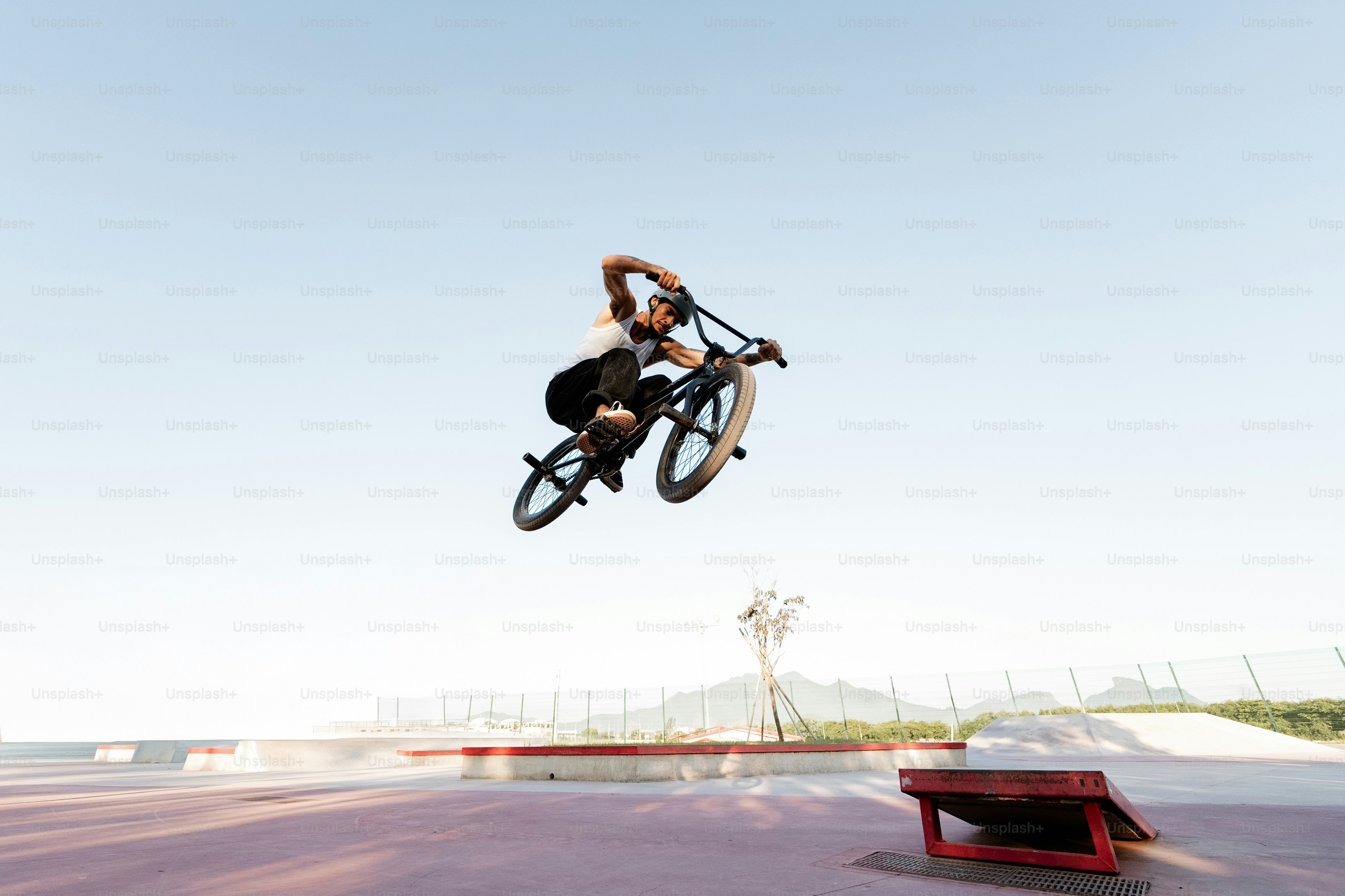 A man flying through the air while riding a bike photo – Blue Image on ...