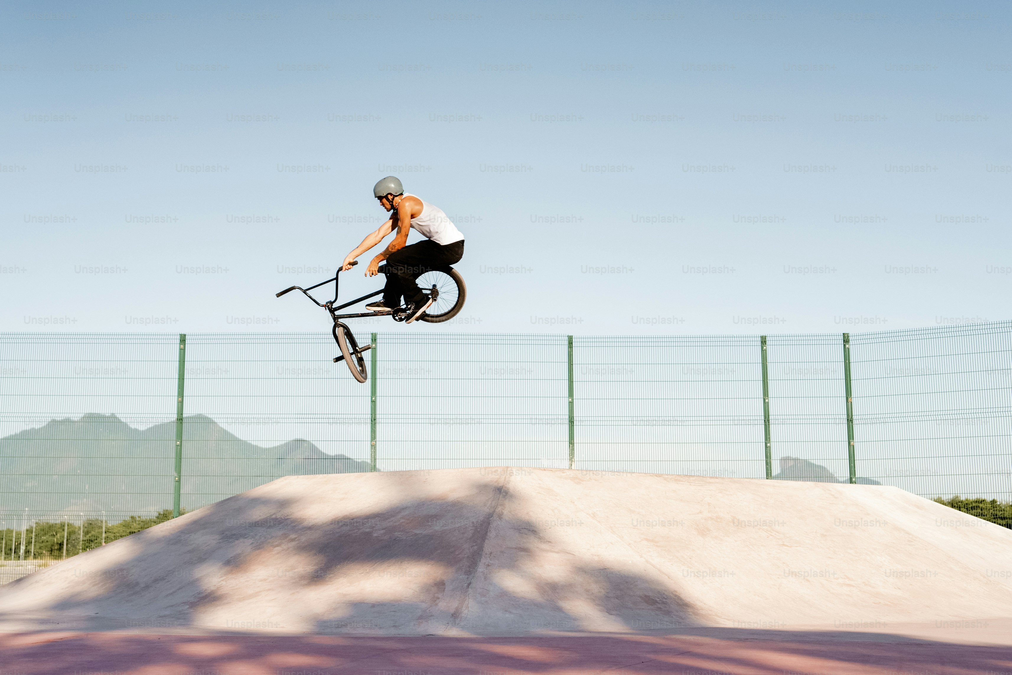 A man flying through the air while riding a bike photo – Bmx Image on ...