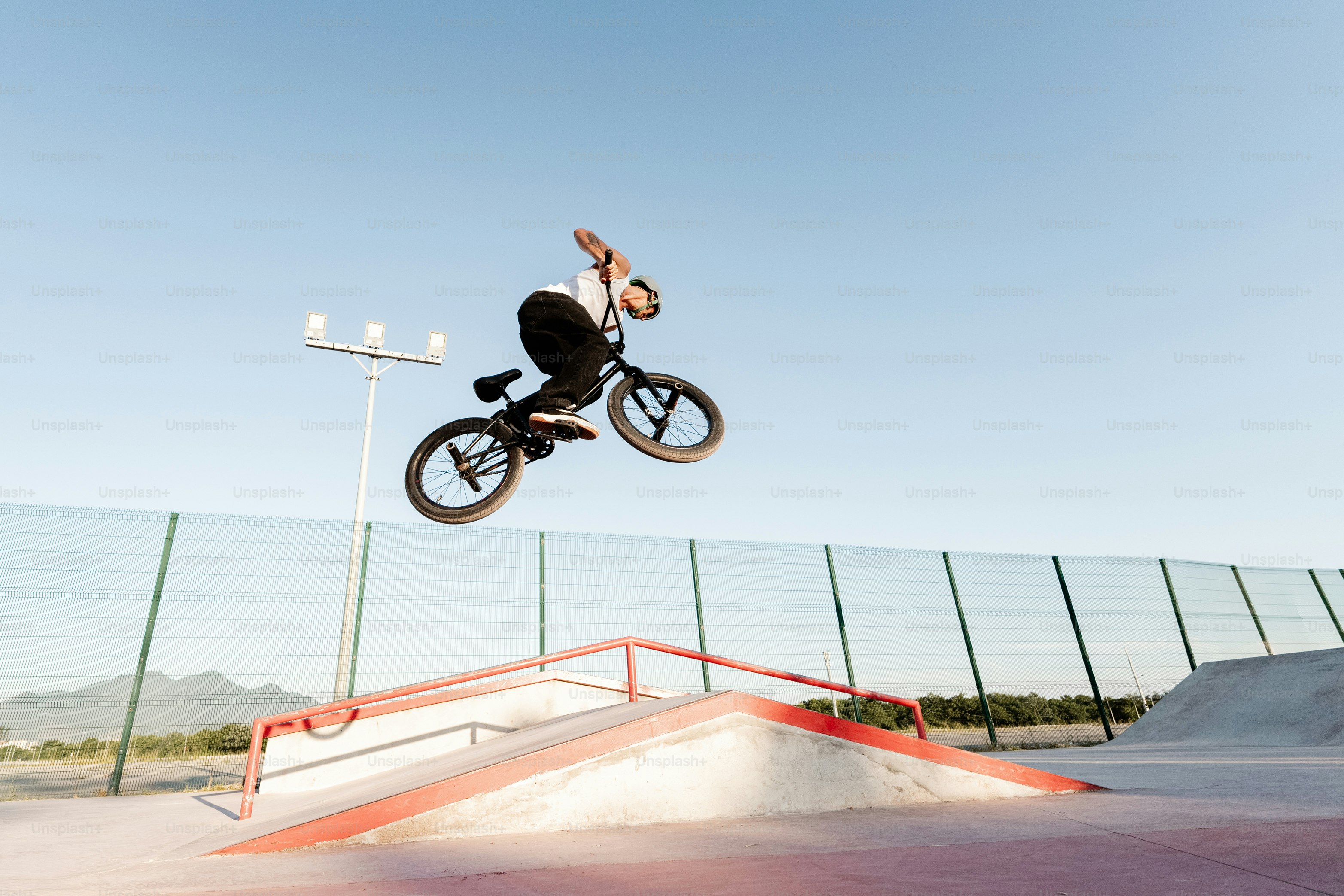 A man flying through the air while riding a bike photo – Bike trends ...