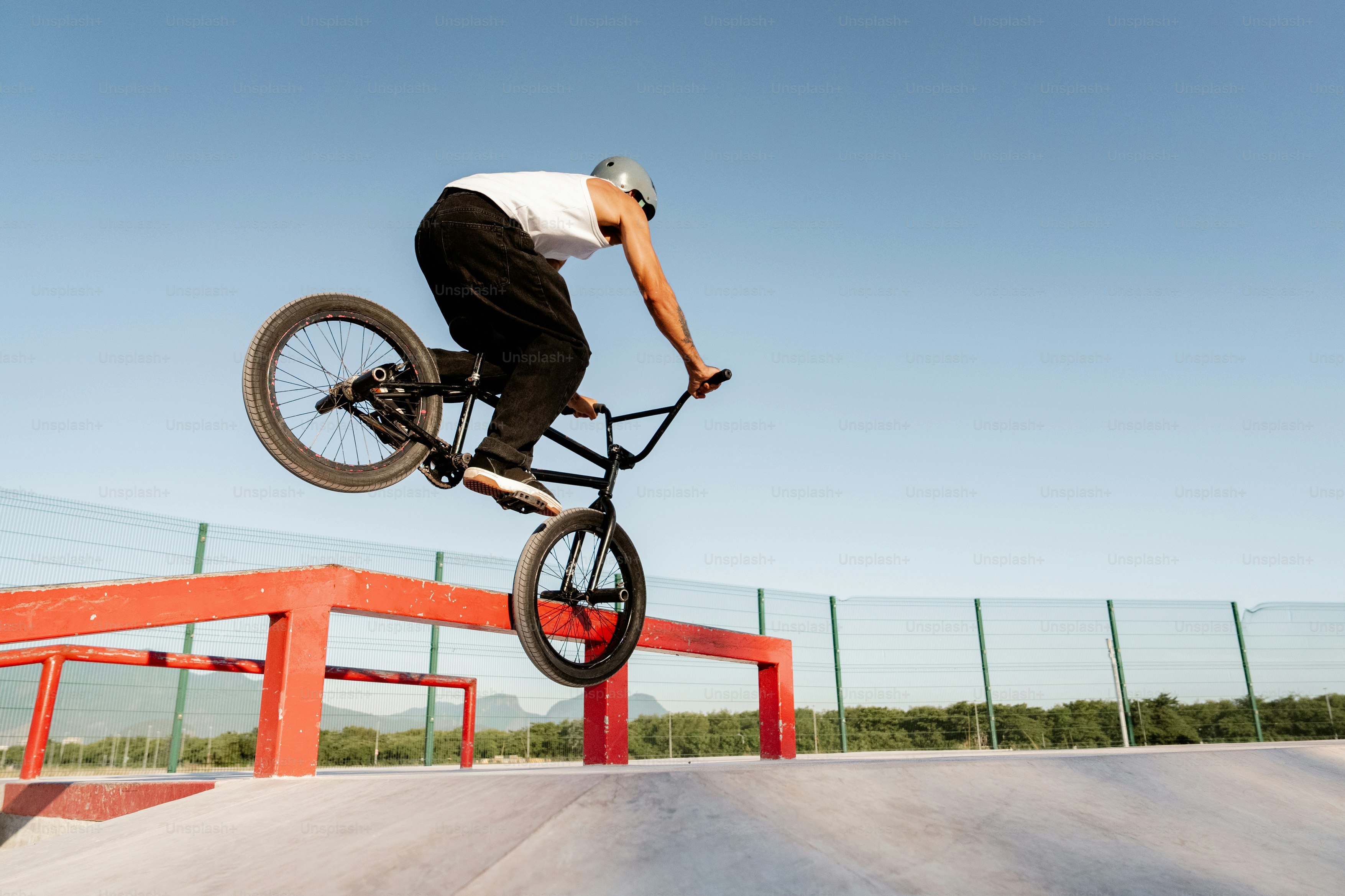 A man riding a bike up the side of a ramp photo – Man Image on Unsplash
