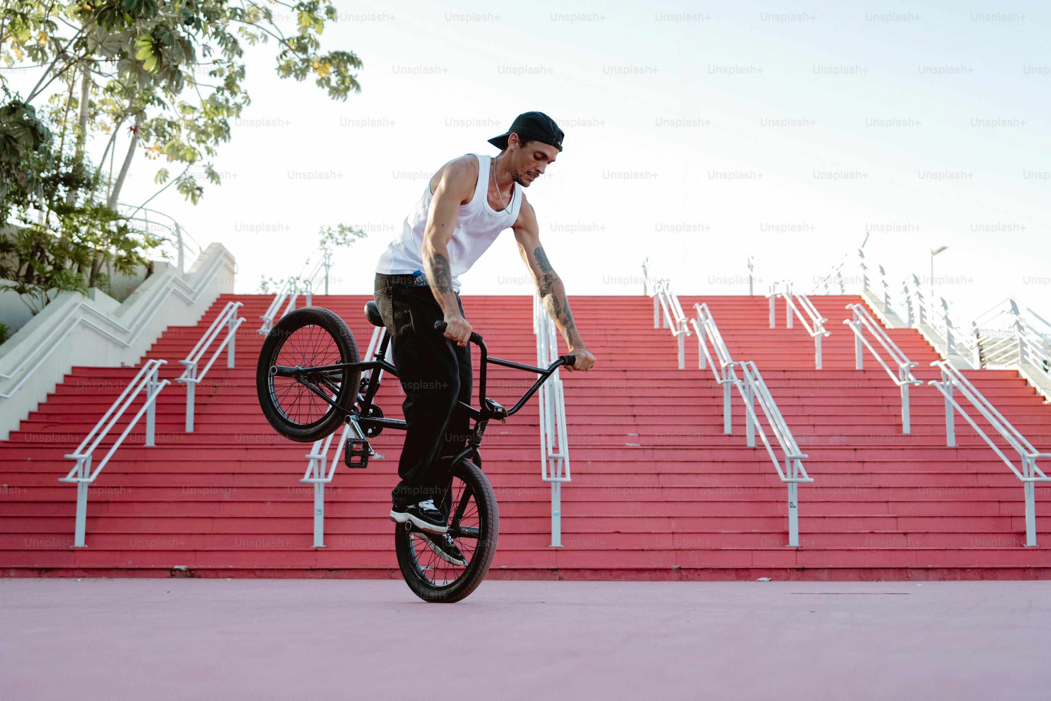A man riding a bike up the side of a ramp photo – Bike trends Image on ...