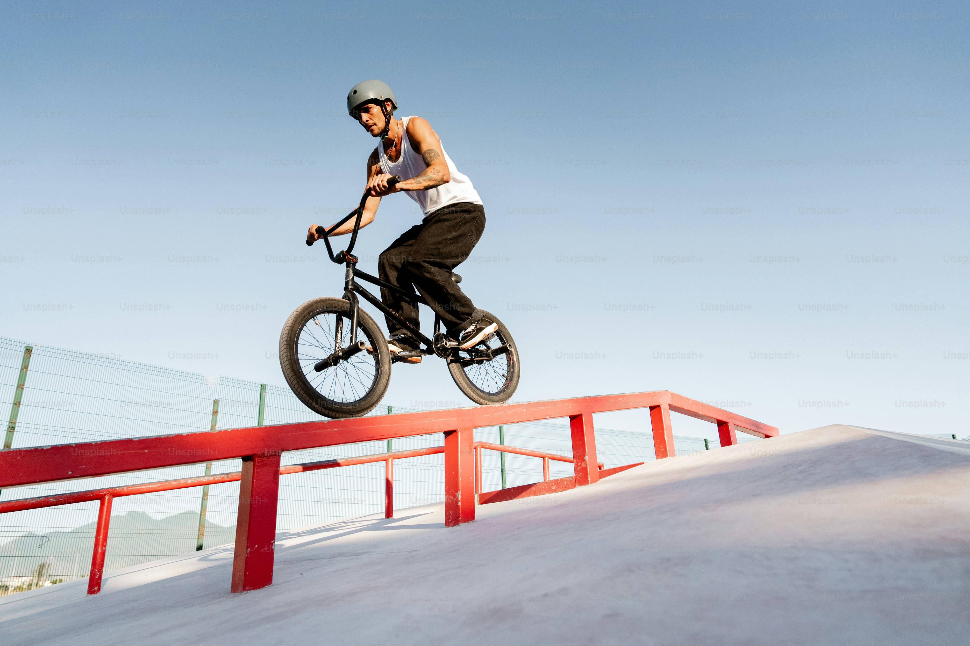 A man flying through the air while riding a bike photo – Man Image on ...