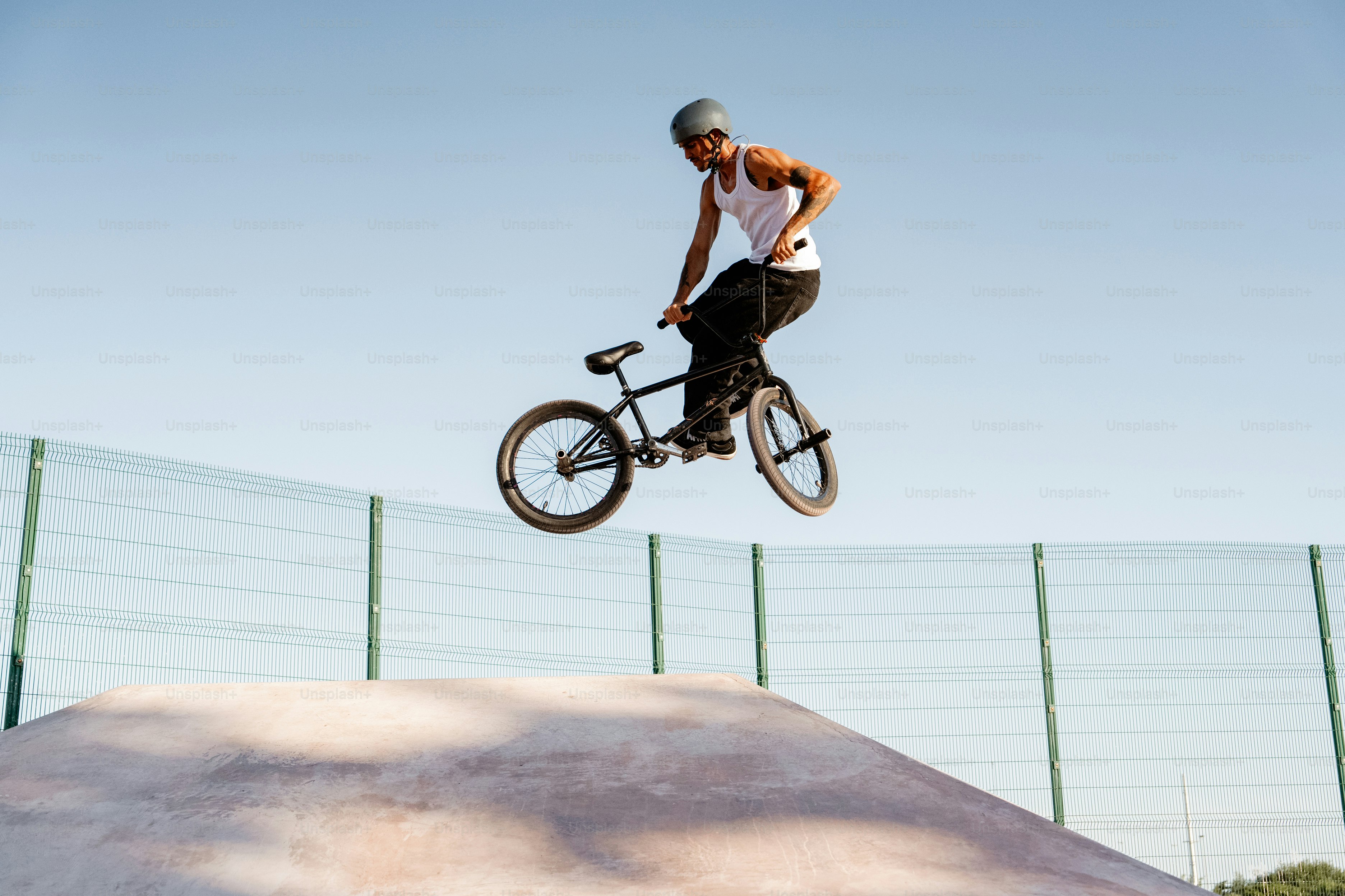 A man riding a bike up the side of a ramp photo – Man Image on Unsplash