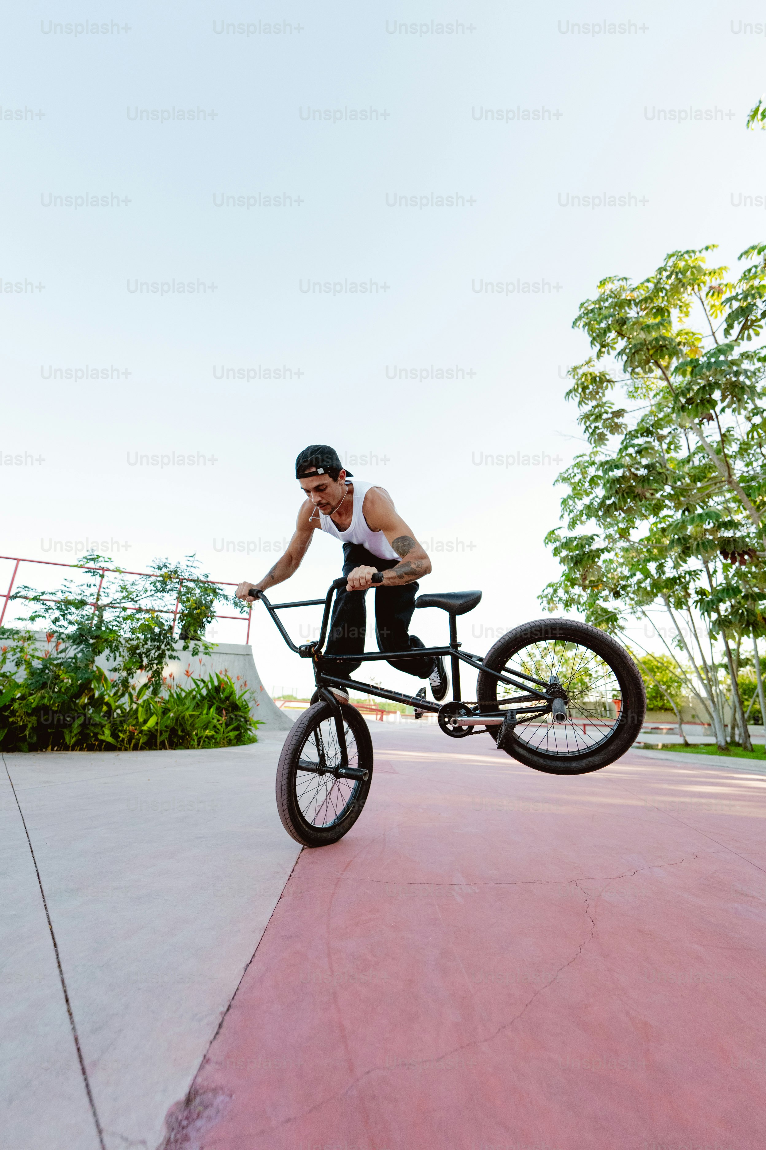 A man flying through the air while riding a bike photo – Man Image on ...