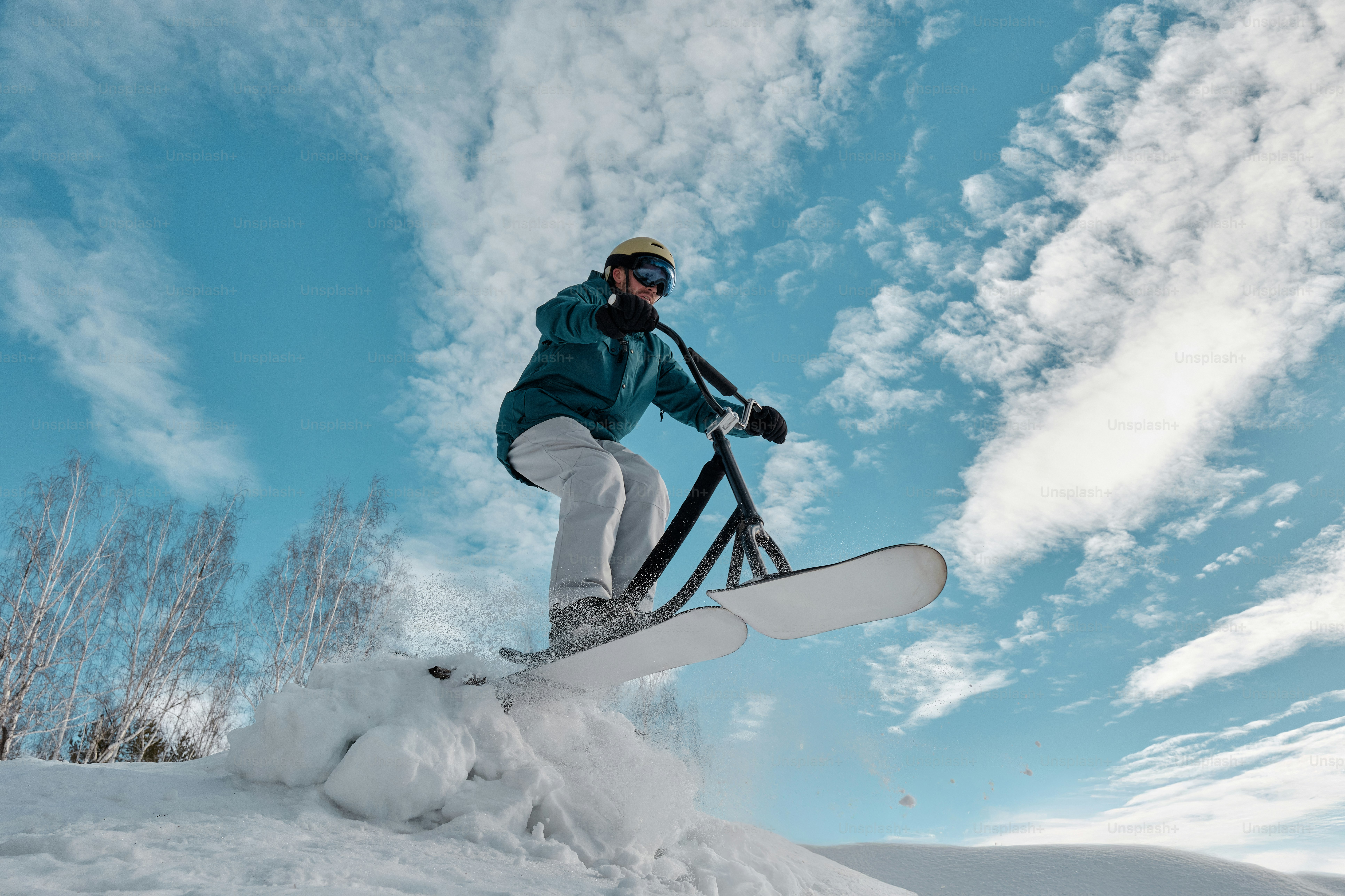 A man riding a snowboard down a snow covered slope