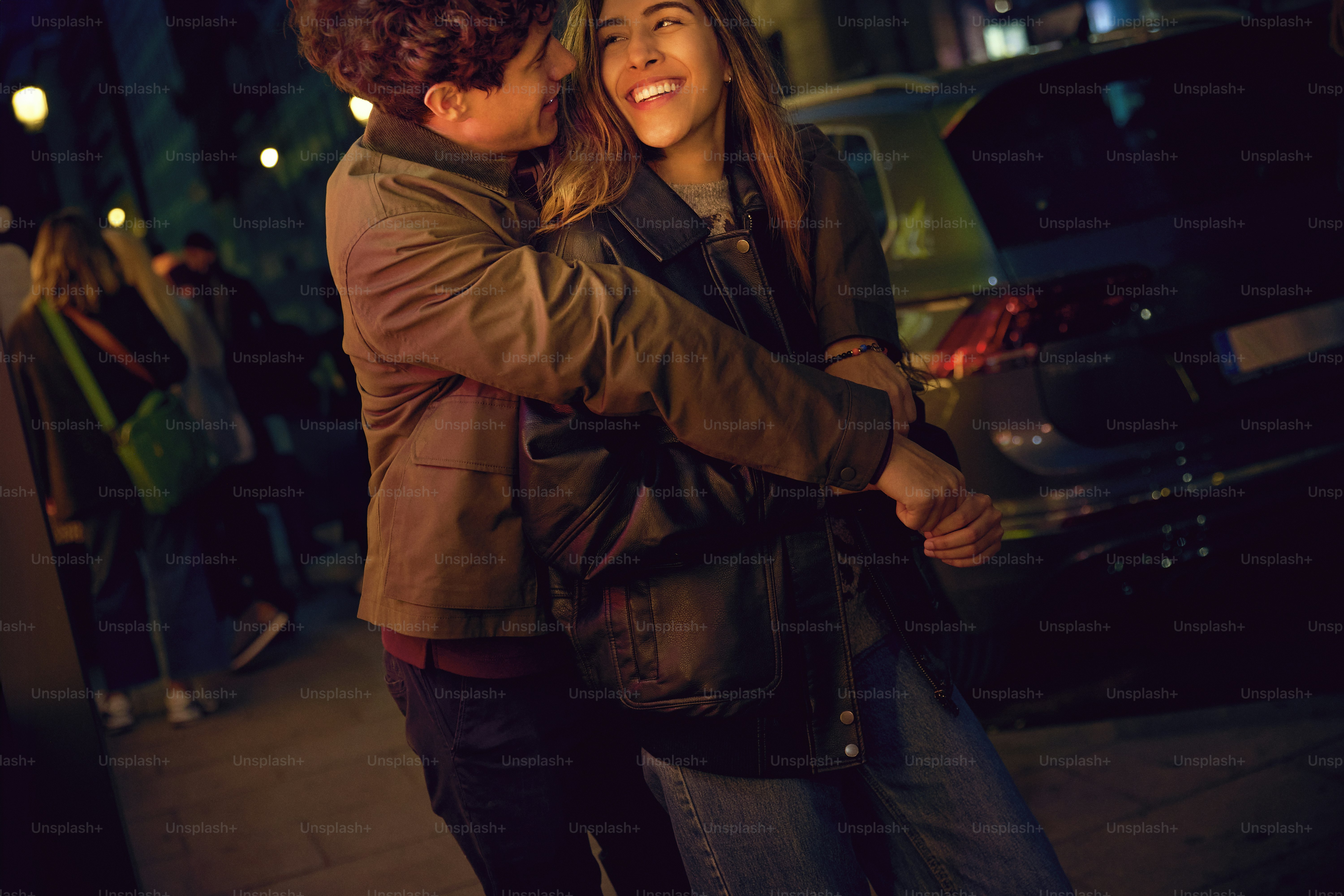 A man hugging a woman on the street photo – Night out Image on Unsplash