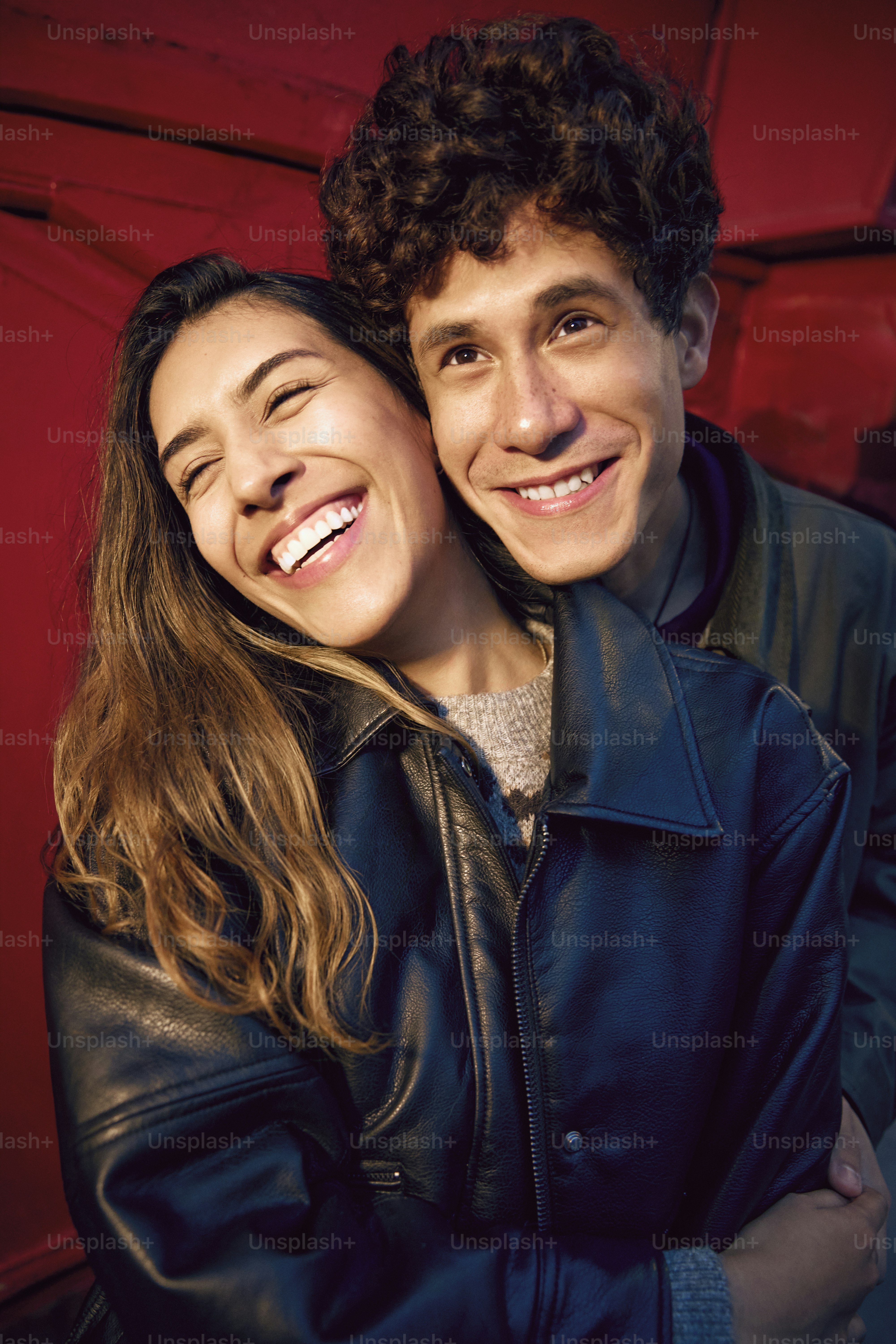 A man and a woman are smiling for the camera