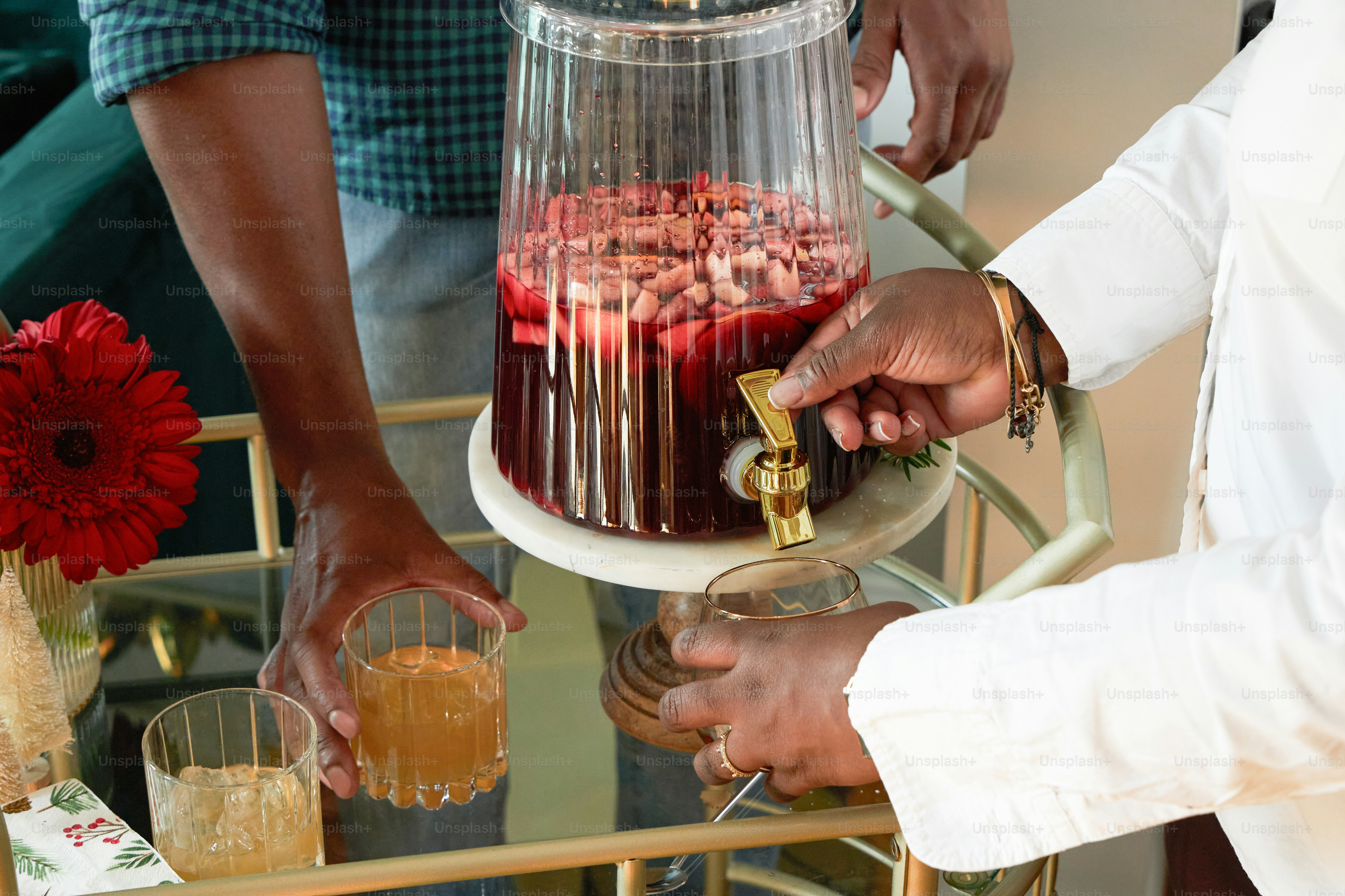 A group of people standing around a cake on a table