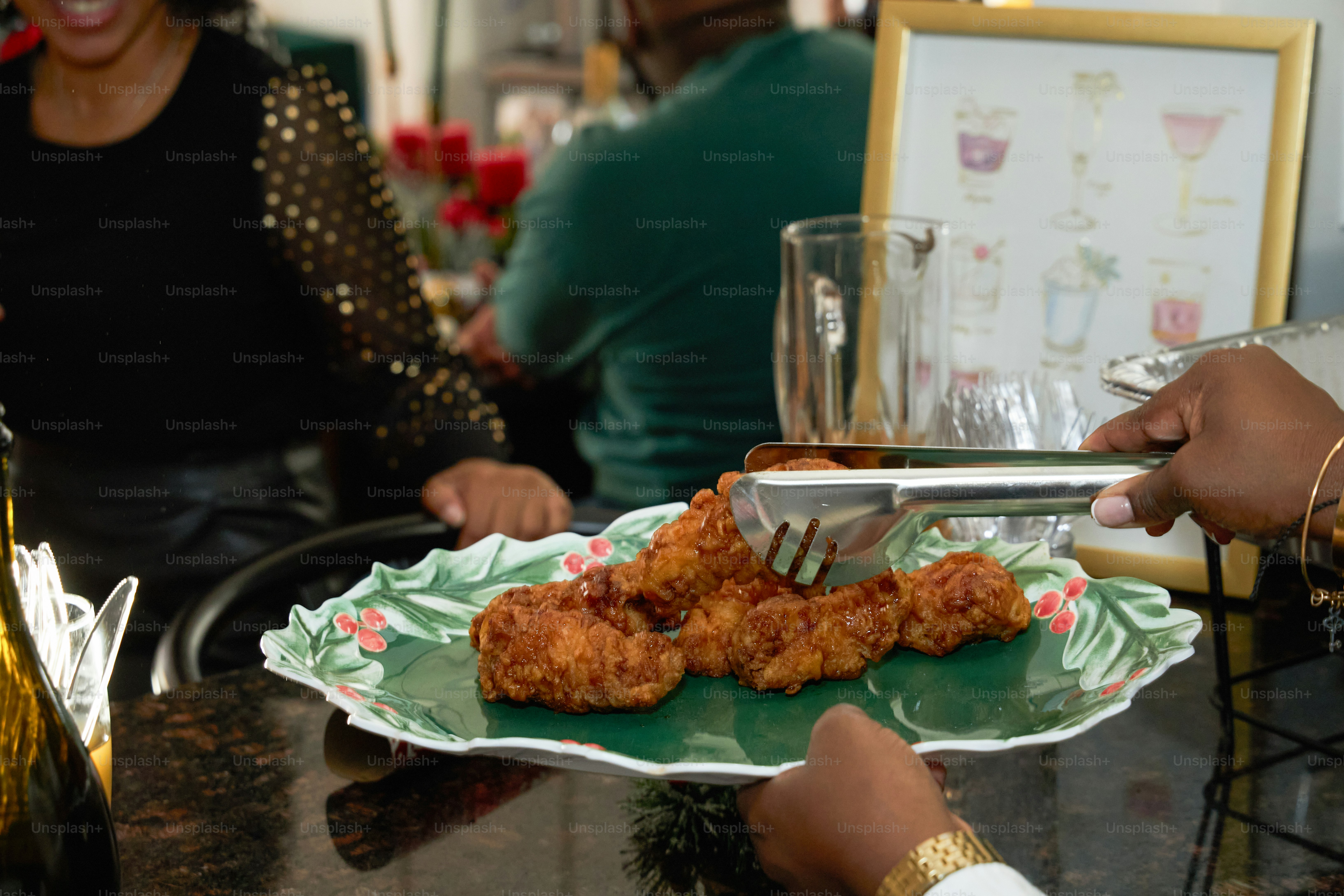 A group of people sitting around a table with food on it