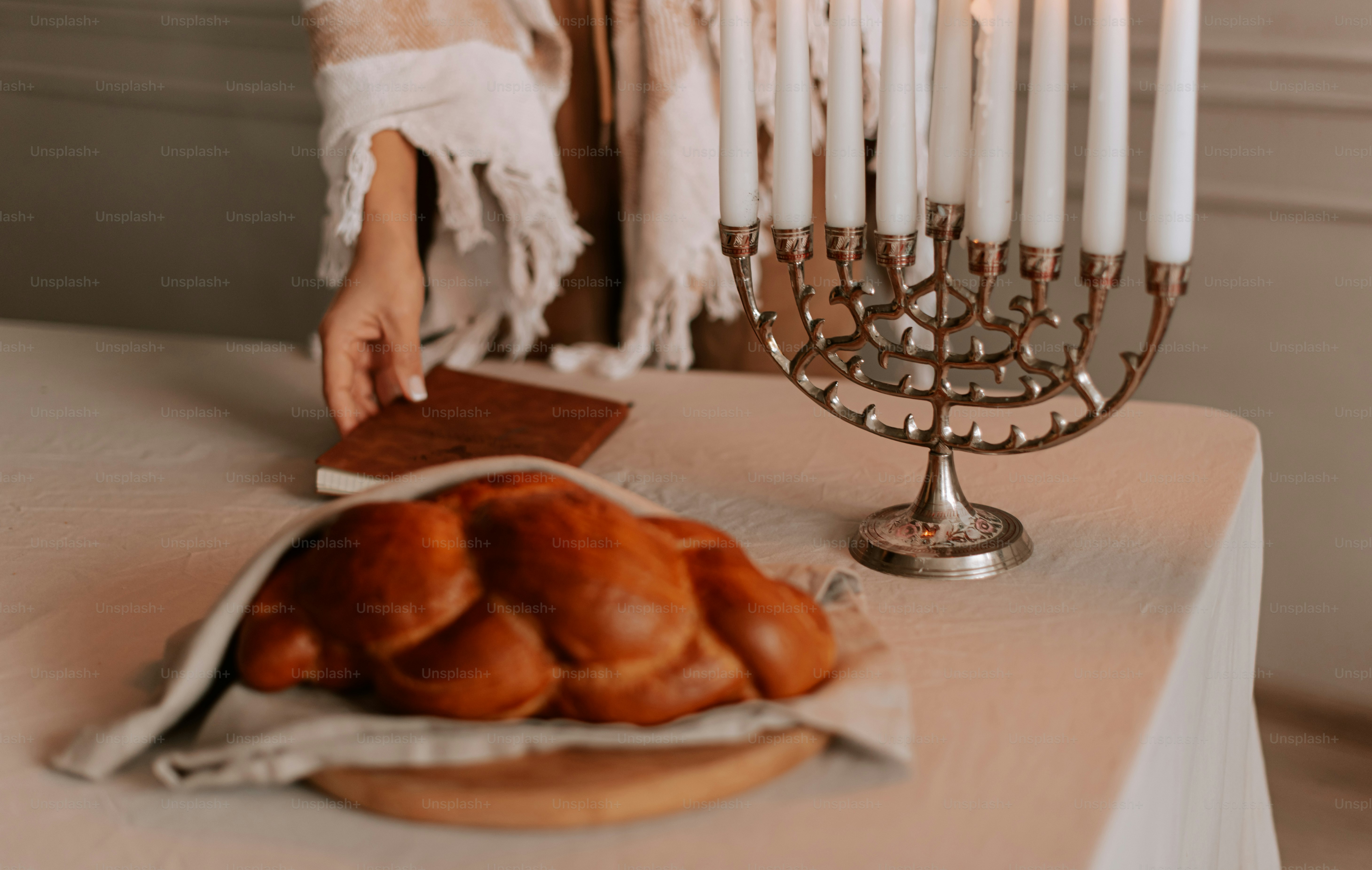 A woman standing in front of a menorah