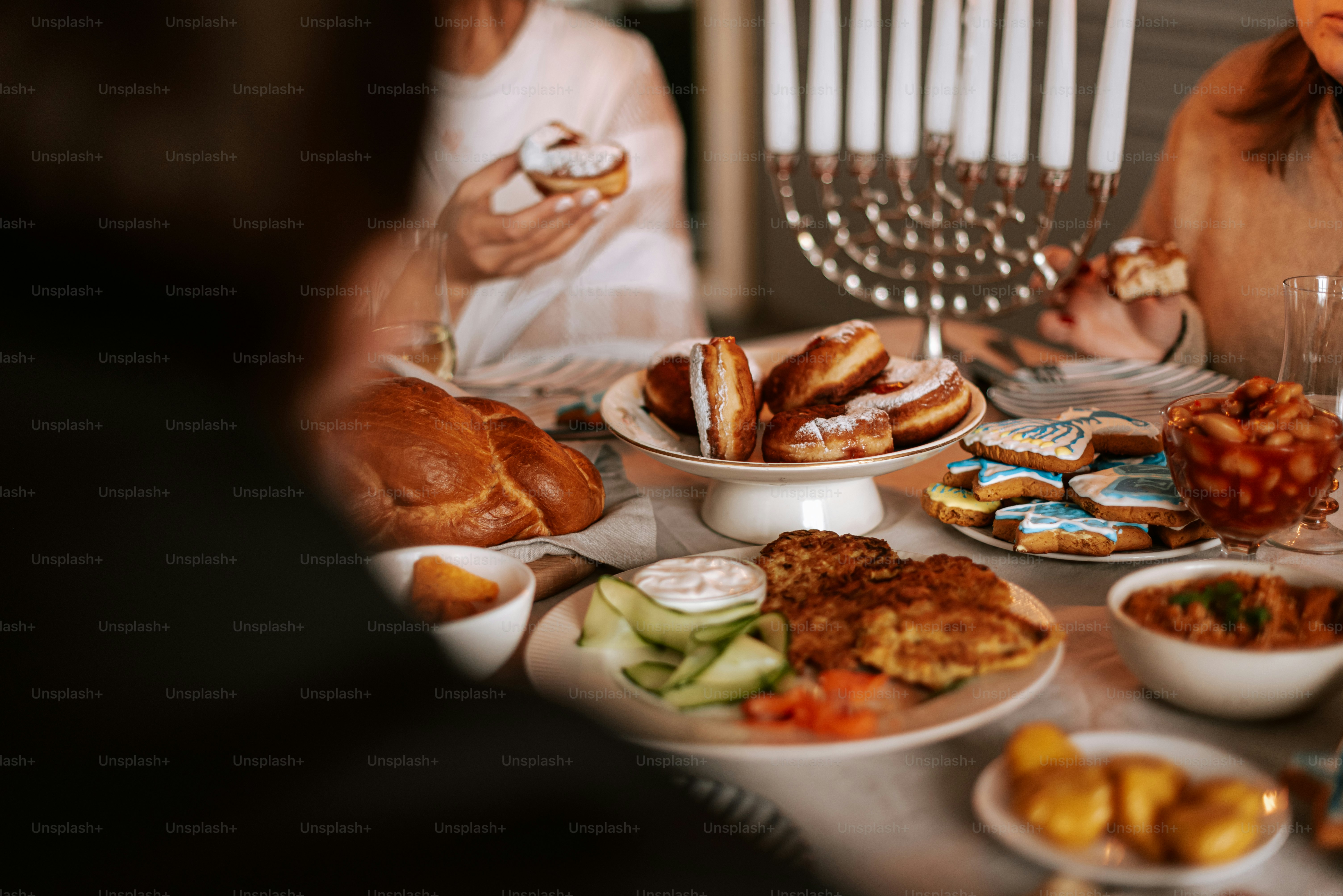 A group of people sitting around a table with food