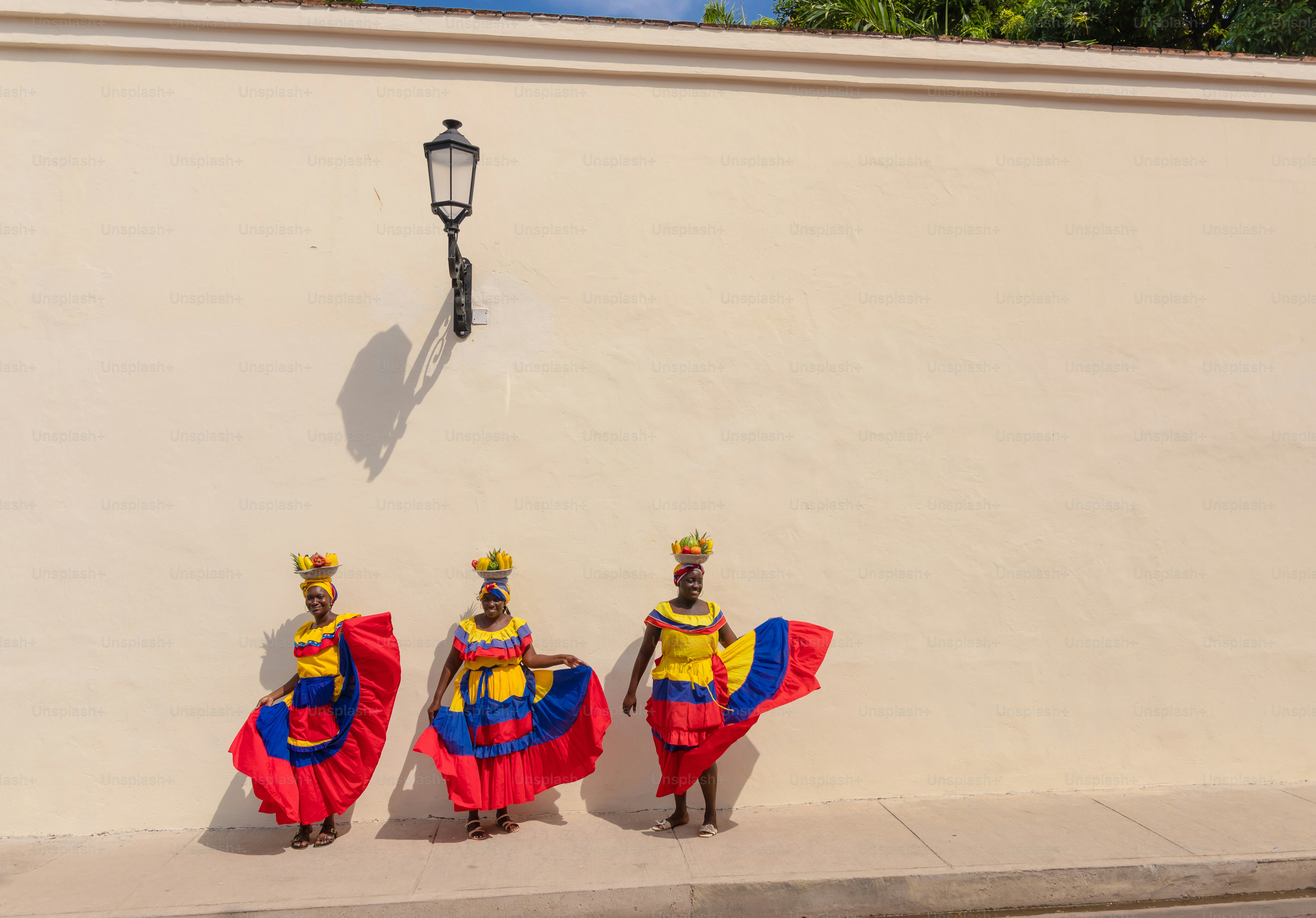 A group of people standing next to a wall