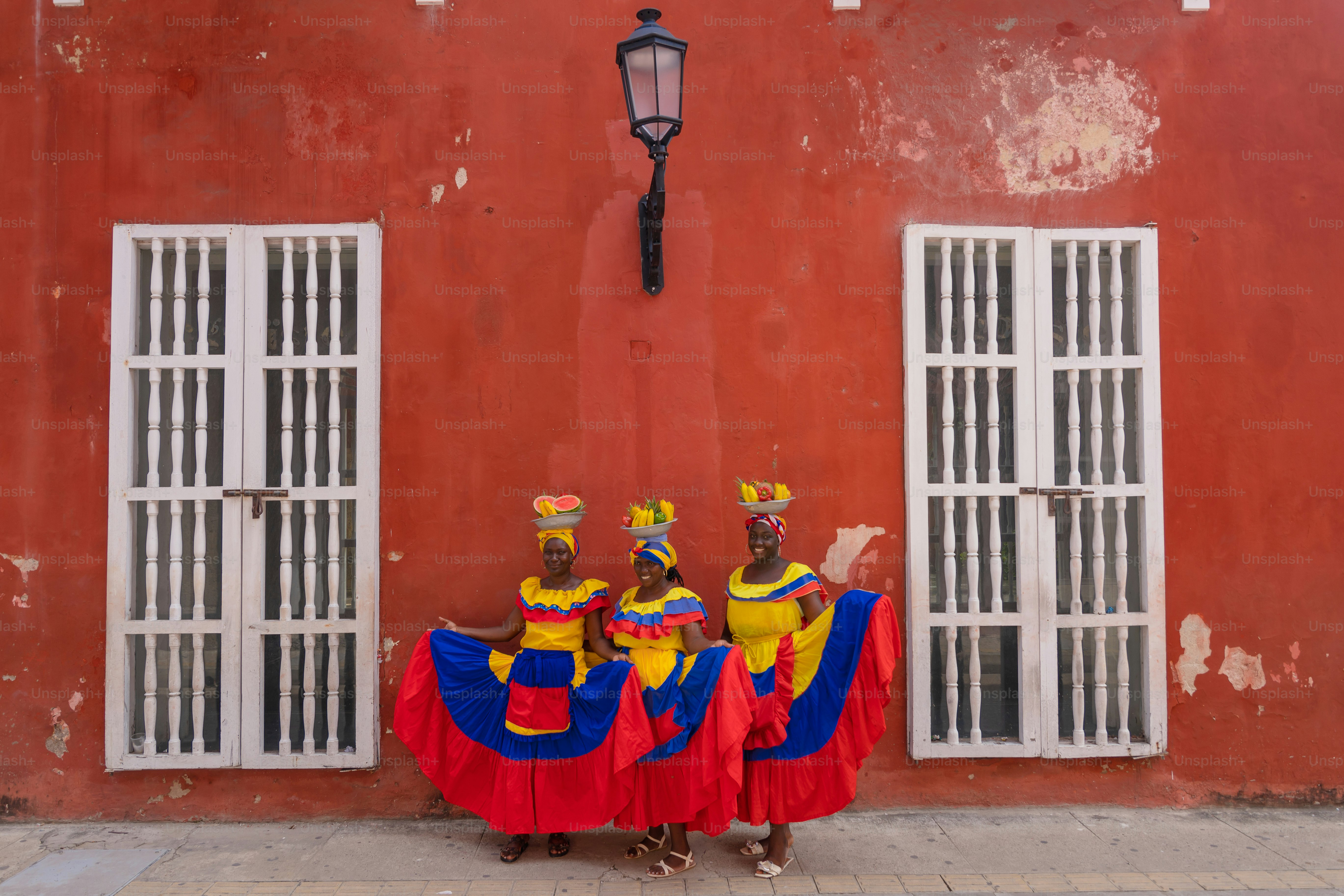 A group of people standing in front of a red building