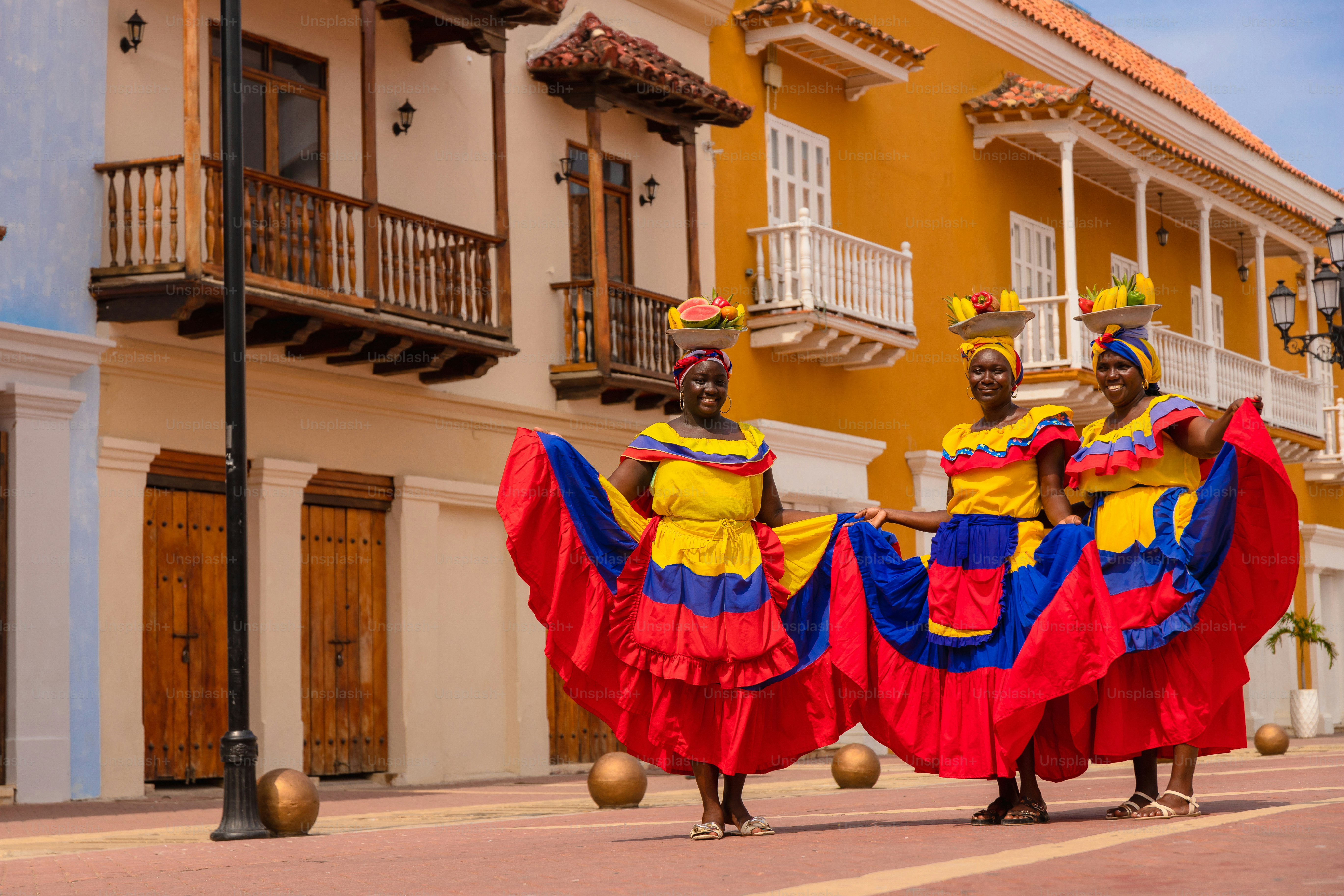 A group of people that are walking down a street