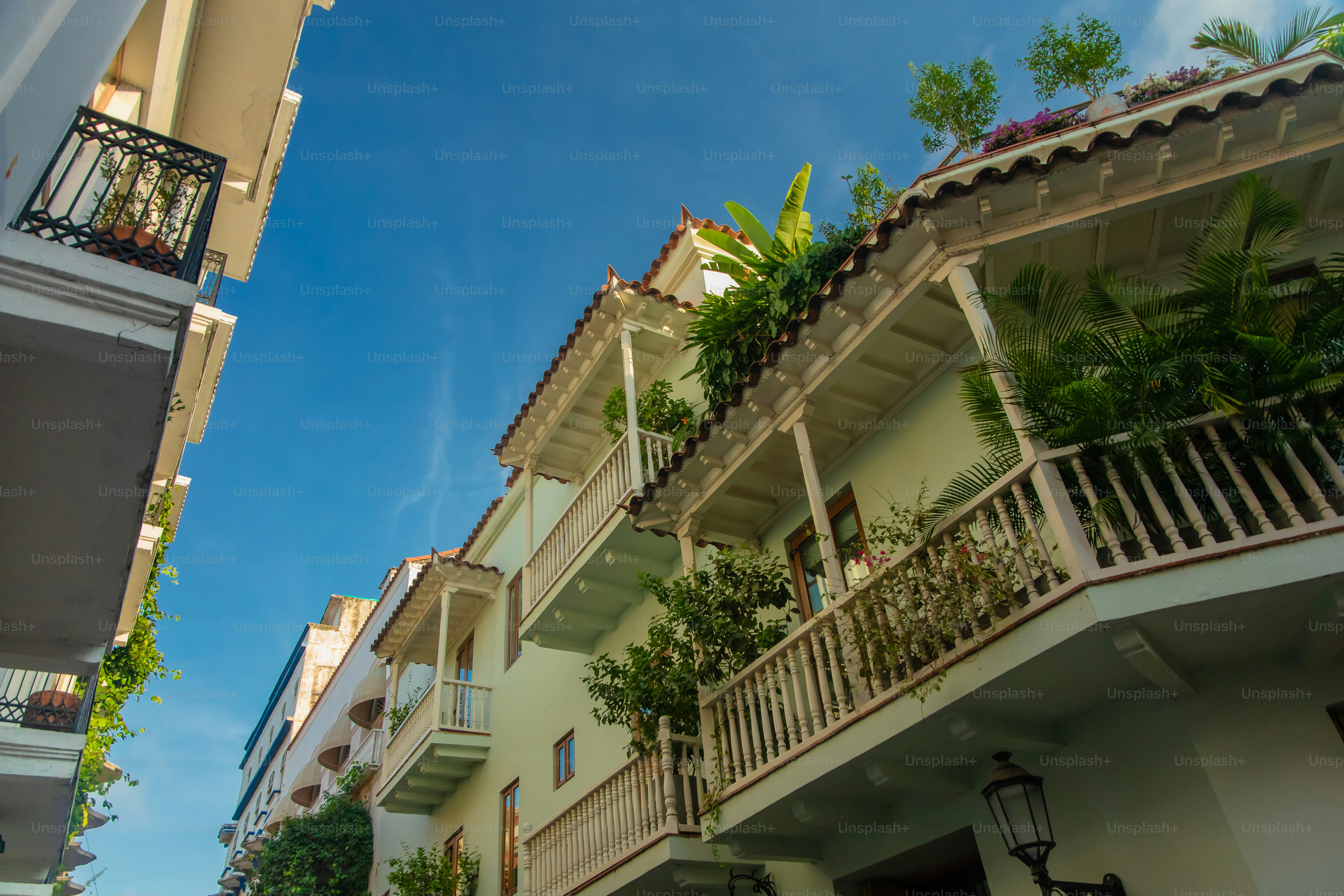 A building with balconies and plants on the balconies