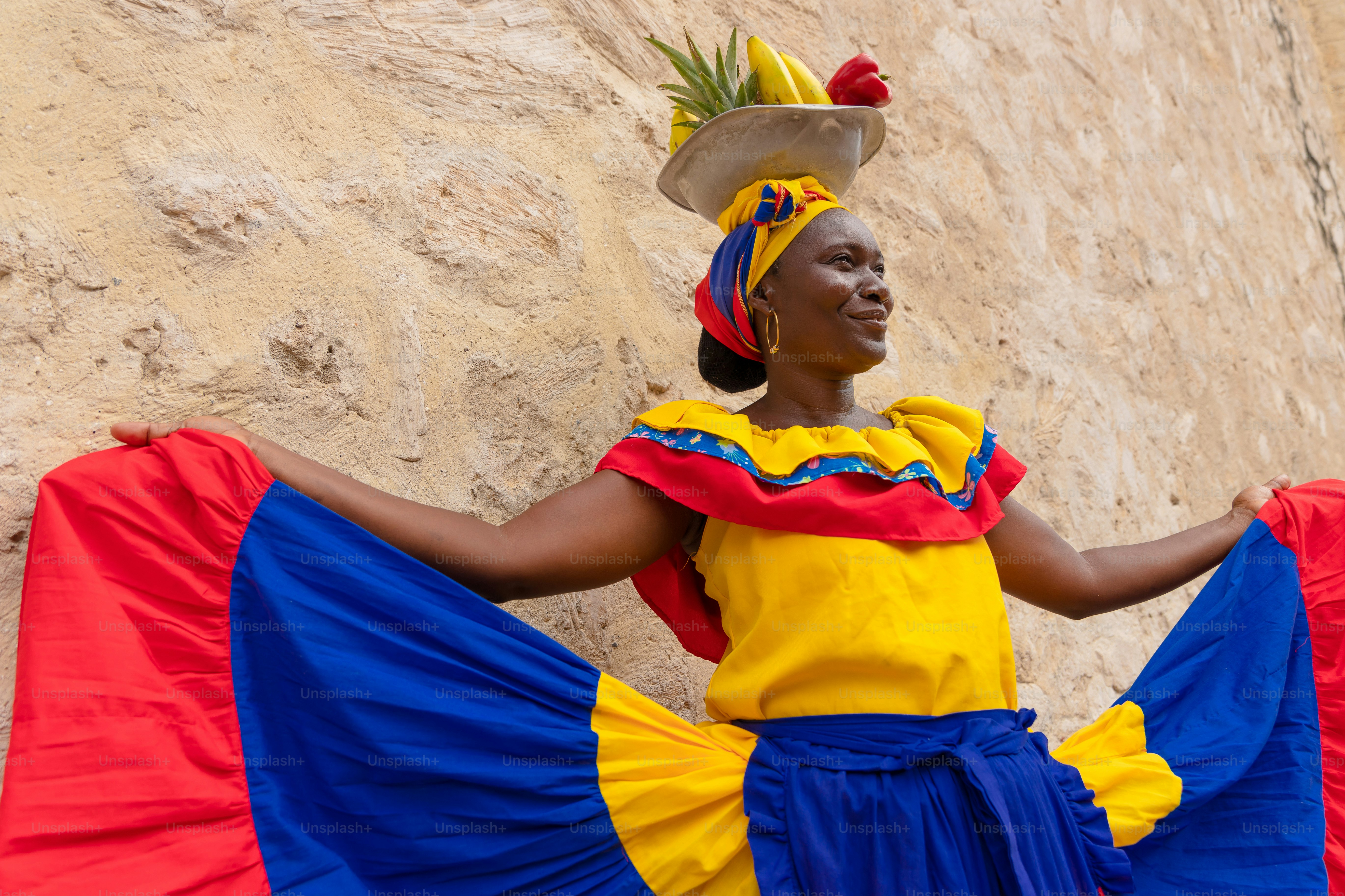 A woman wearing a colorful dress and a hat