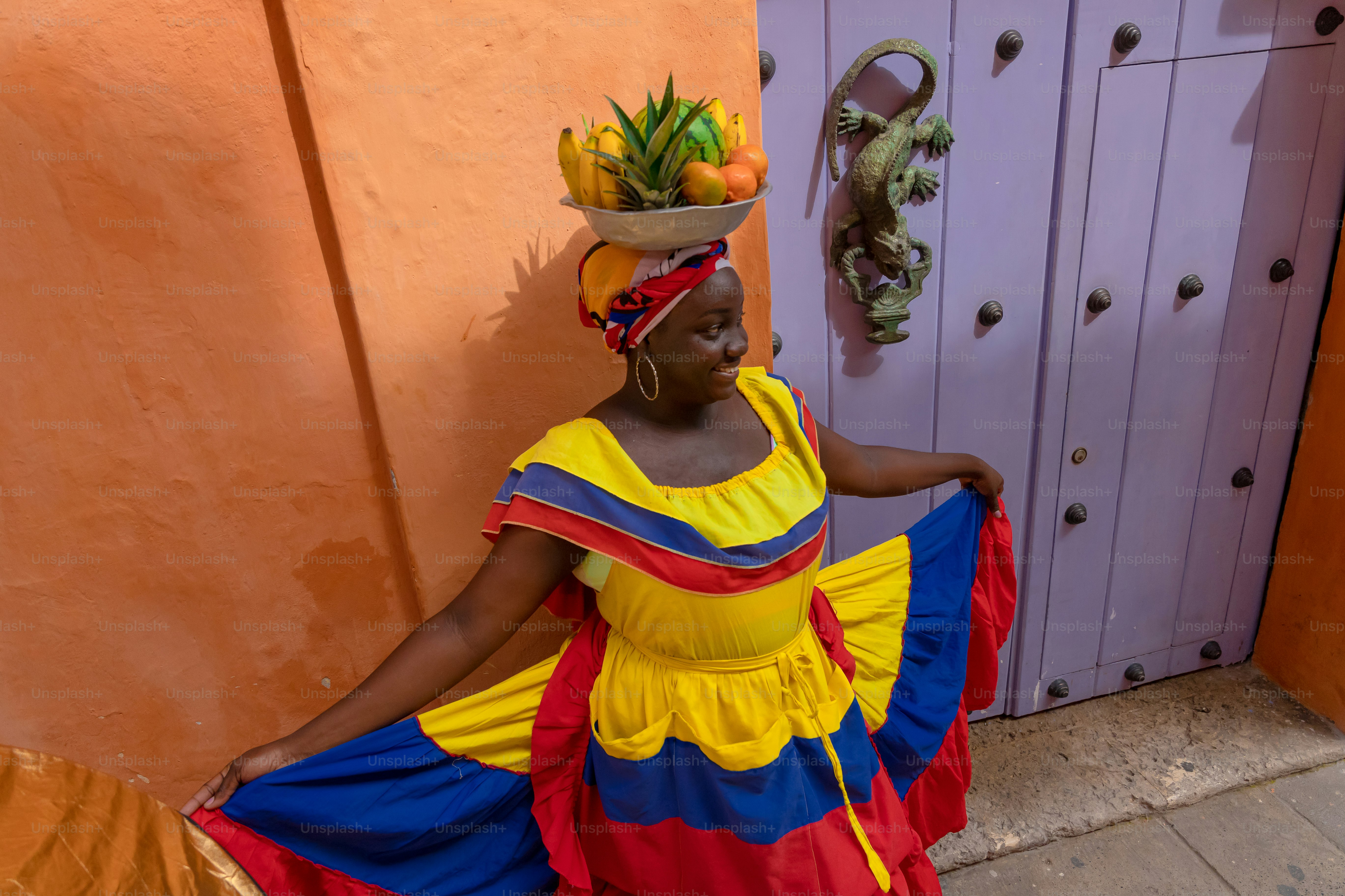 A woman wearing a colorful dress and a hat