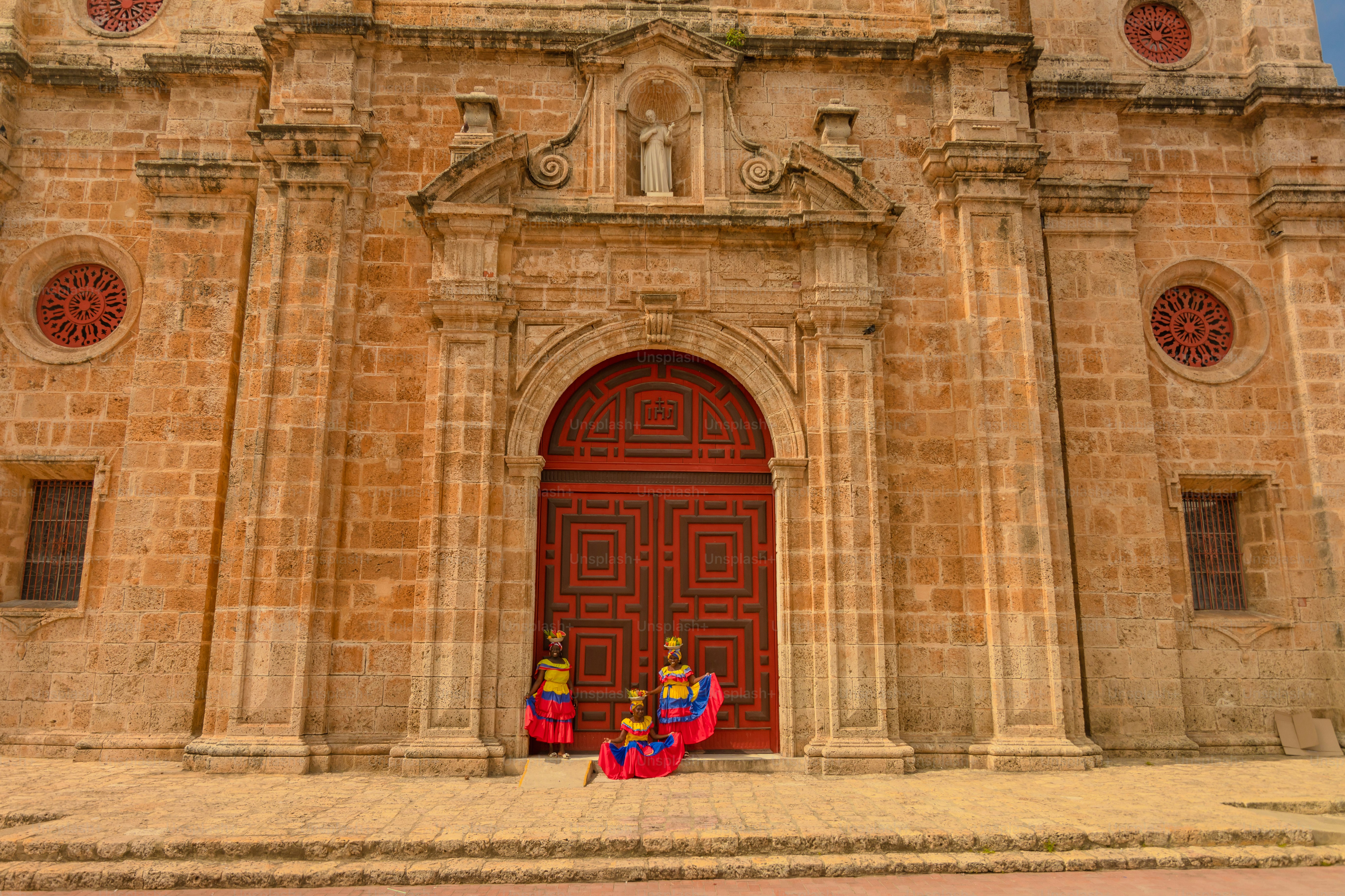 Two people sitting on the steps of a church