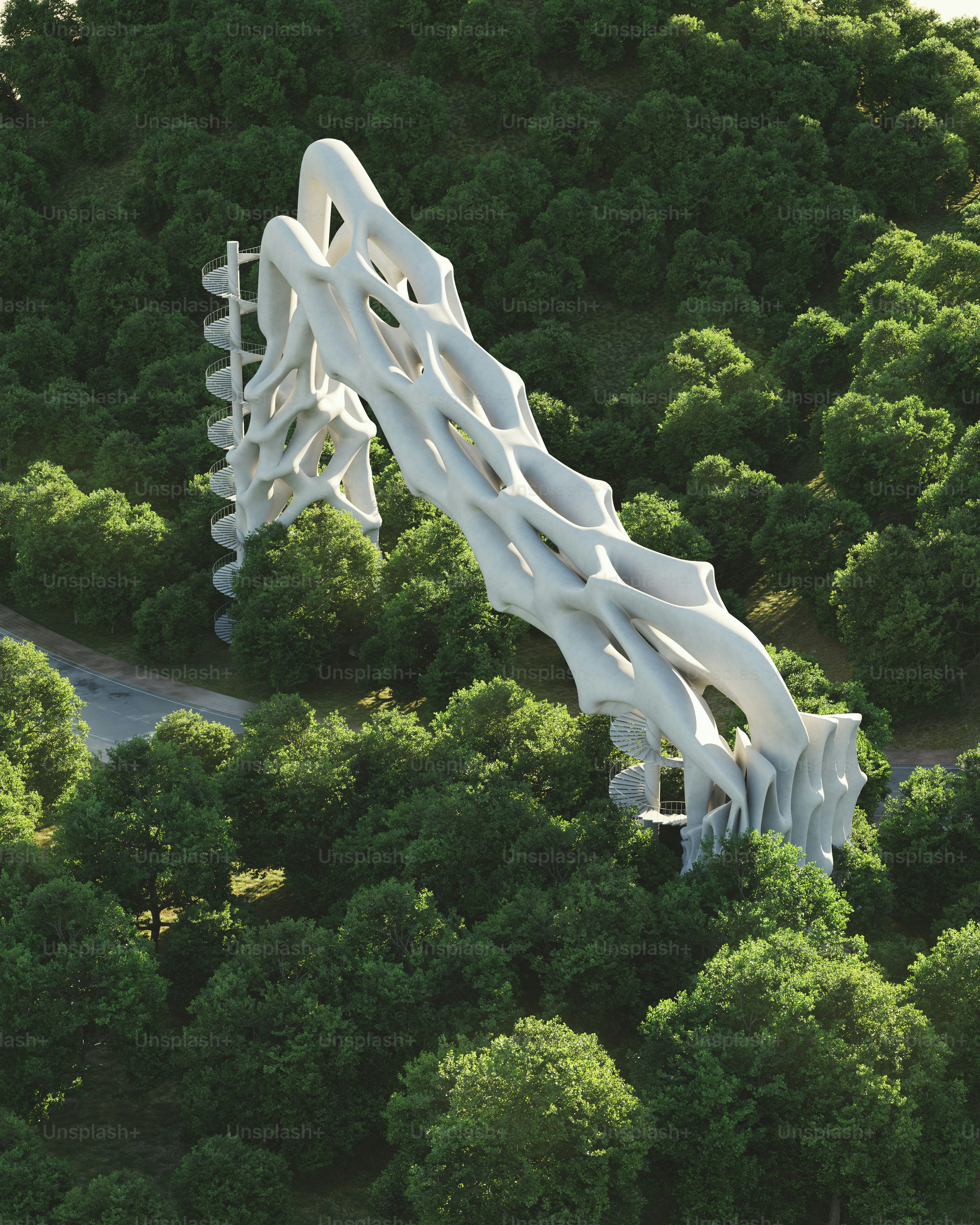 An aerial view of a large white structure in the middle of a forest
