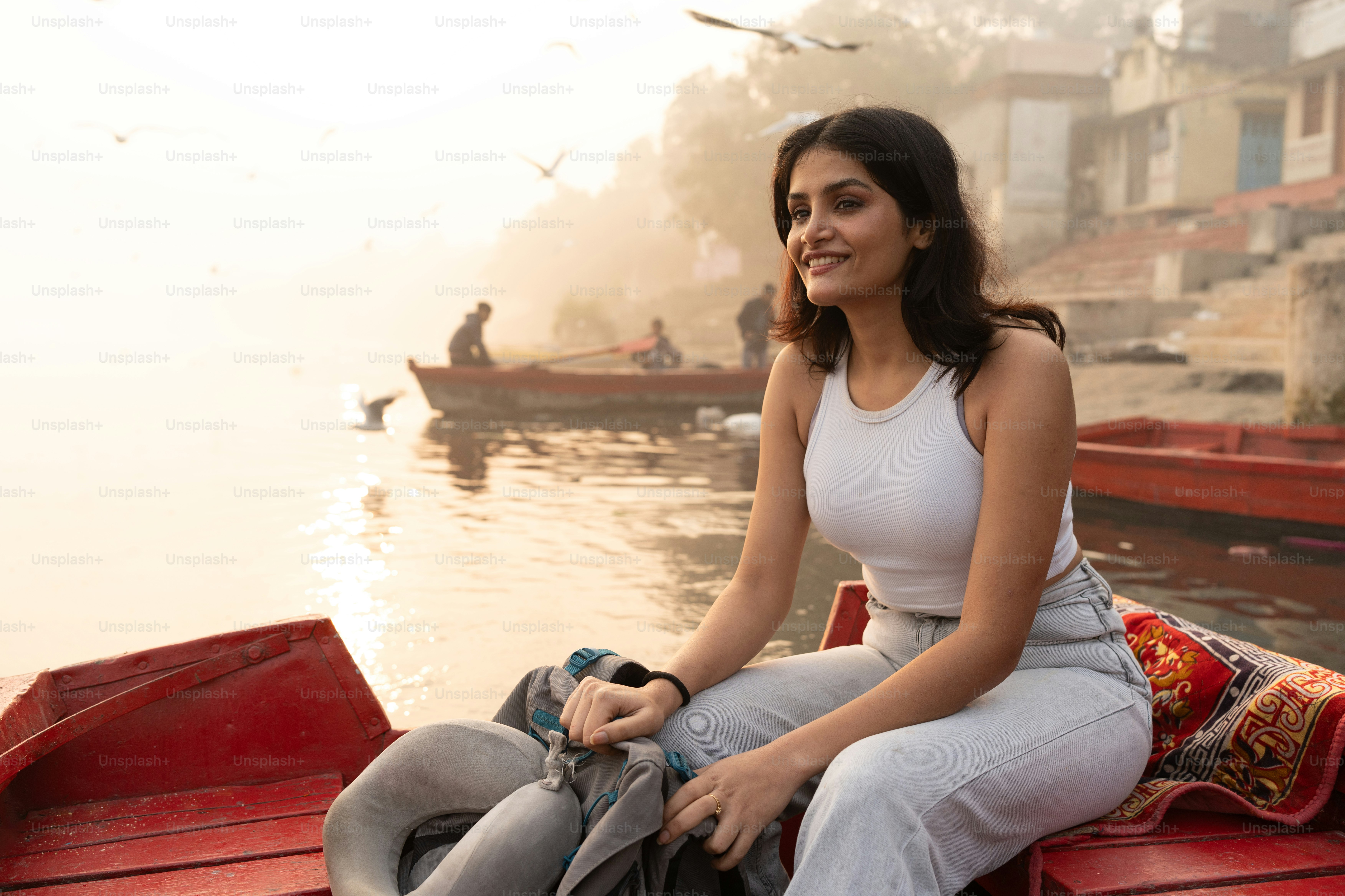 A woman sitting on a boat in the water