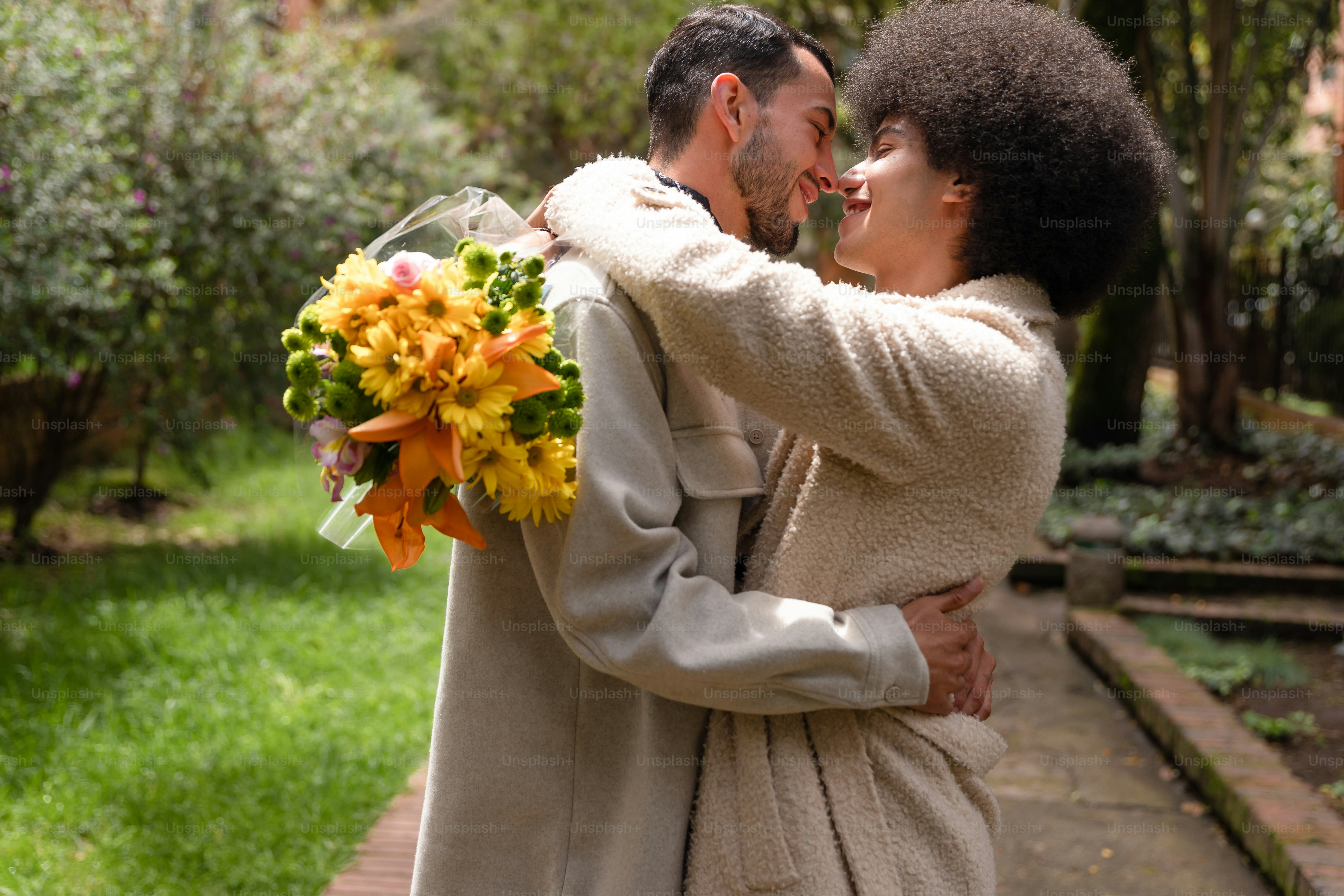 A man and woman embracing each other in a garden