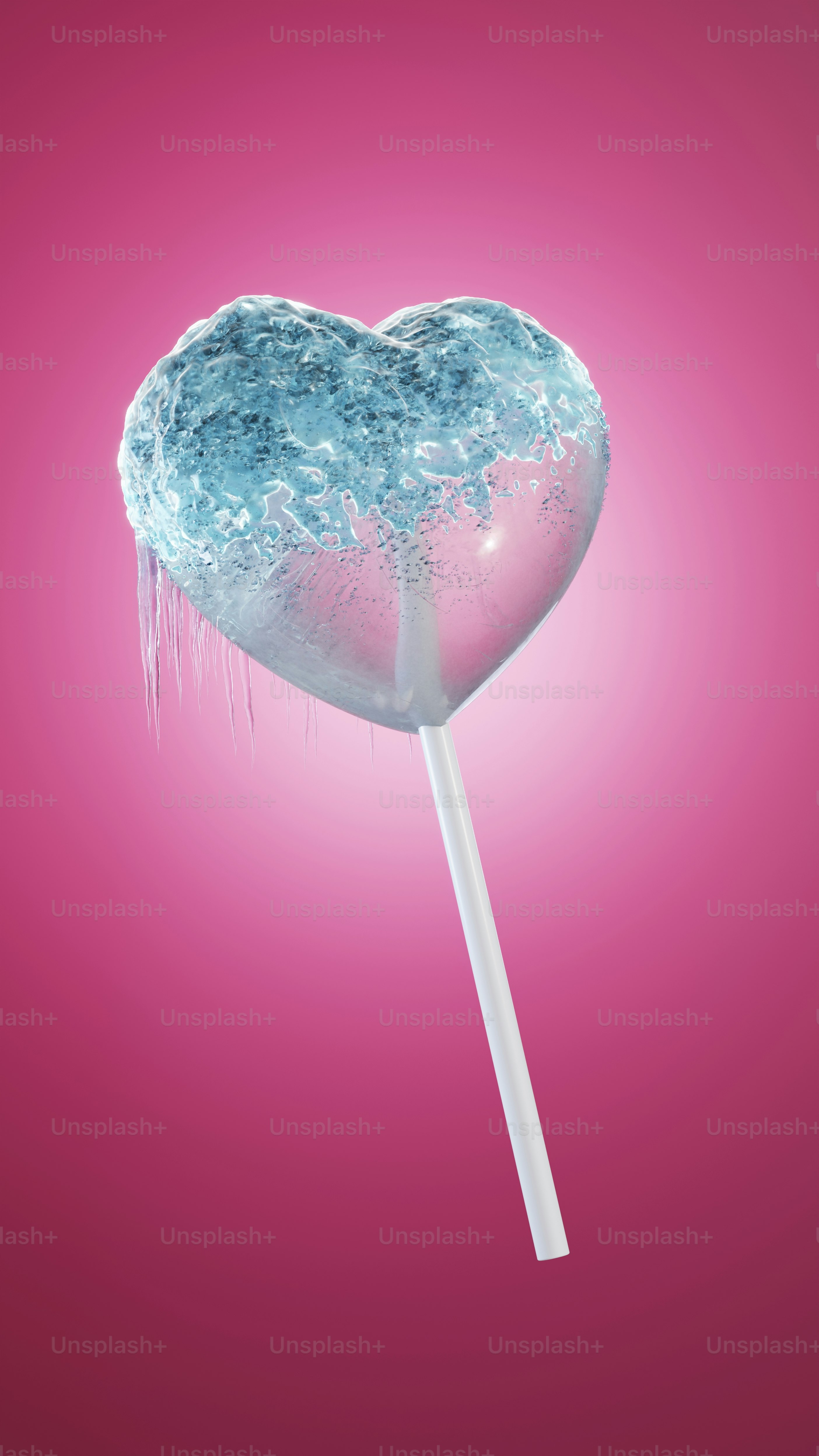 Frozen heartshaped candy on a stick against a pink background is perfect for anti Valentines Day marketing materials or romanticthemed designs. Suitable for greeting cards, social media posts, and websites.