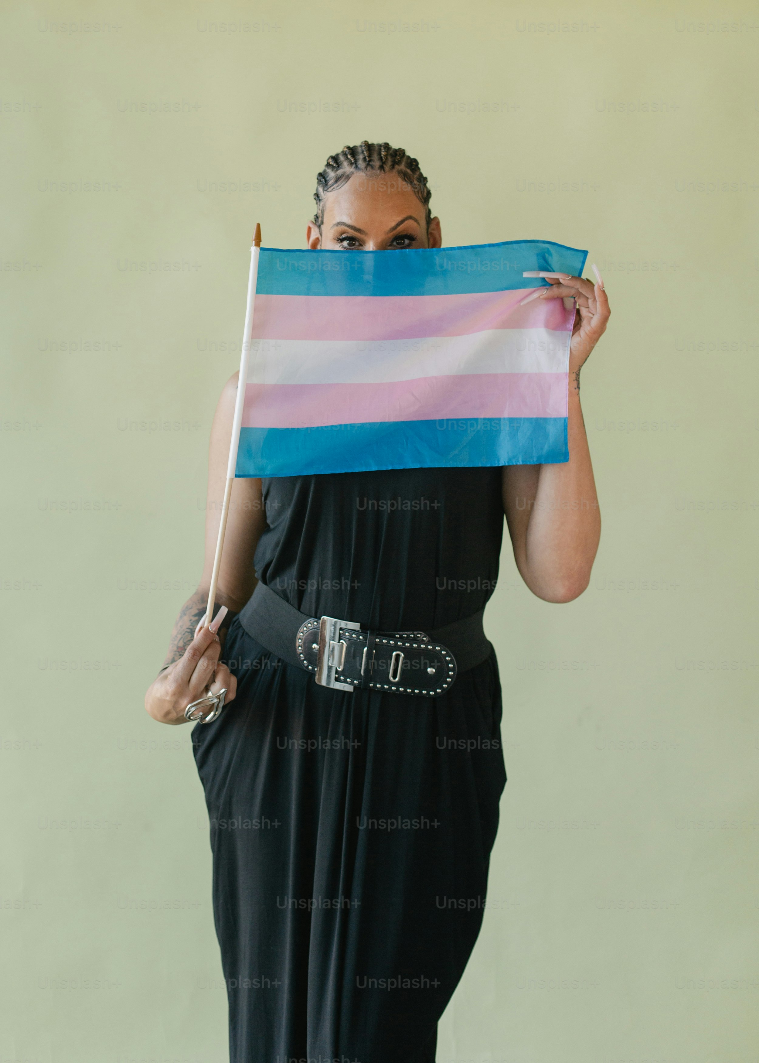 A woman in a black dress holding a flag