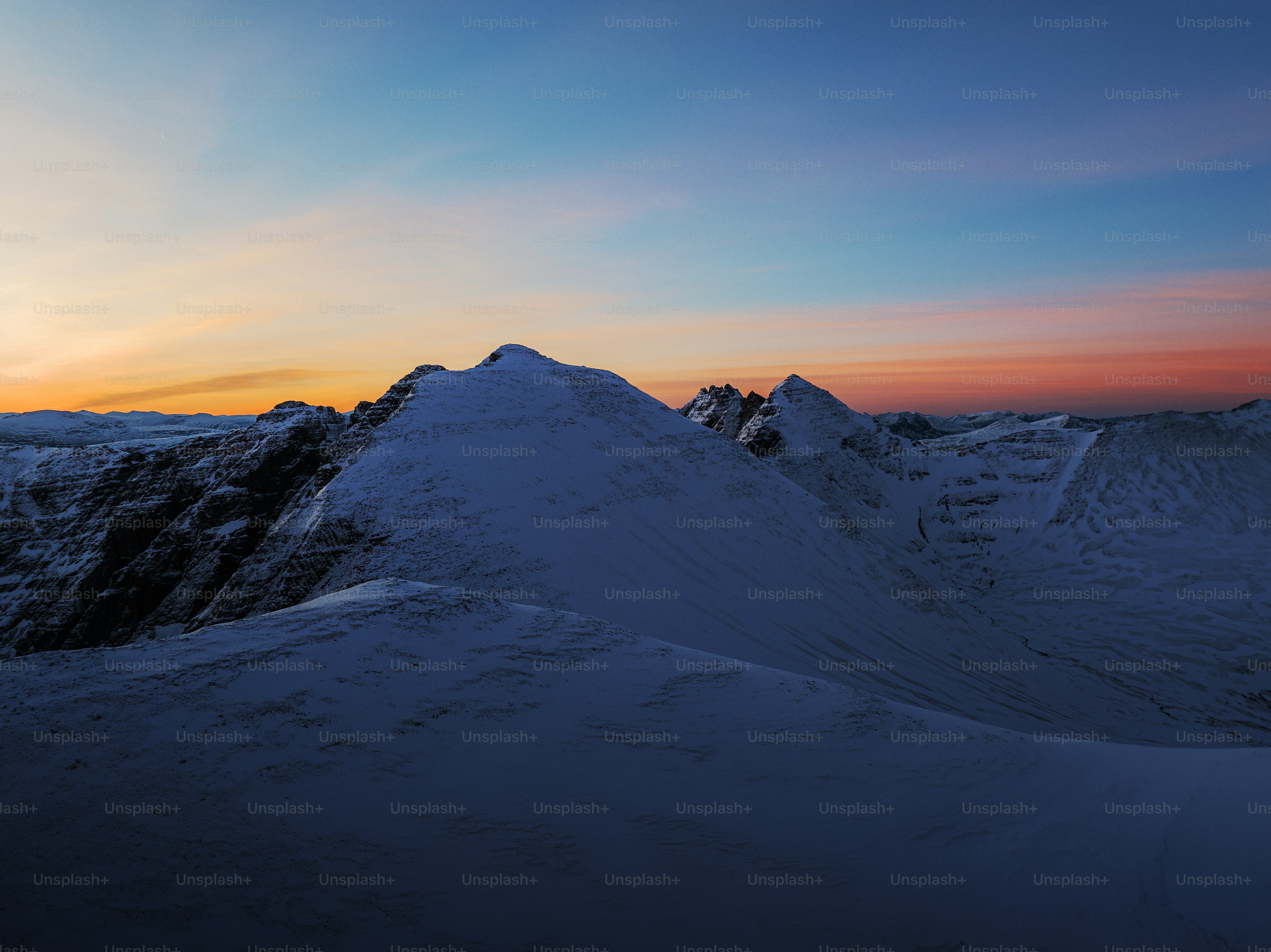 The sun is setting over a snowy mountain photo – Travel Image on Unsplash