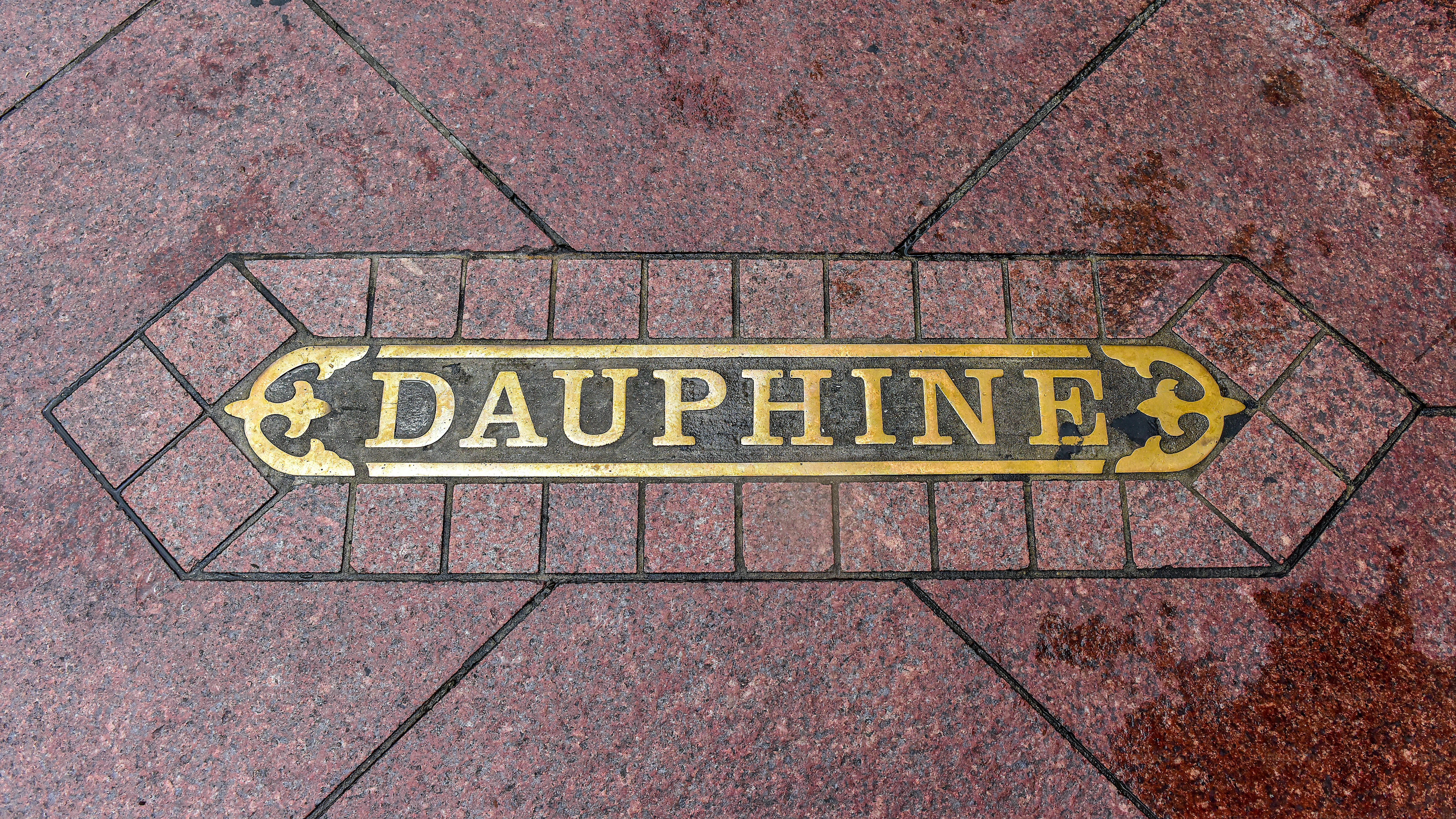 Dauphine Street sign at sidewalk of downtown district, New Orleans.