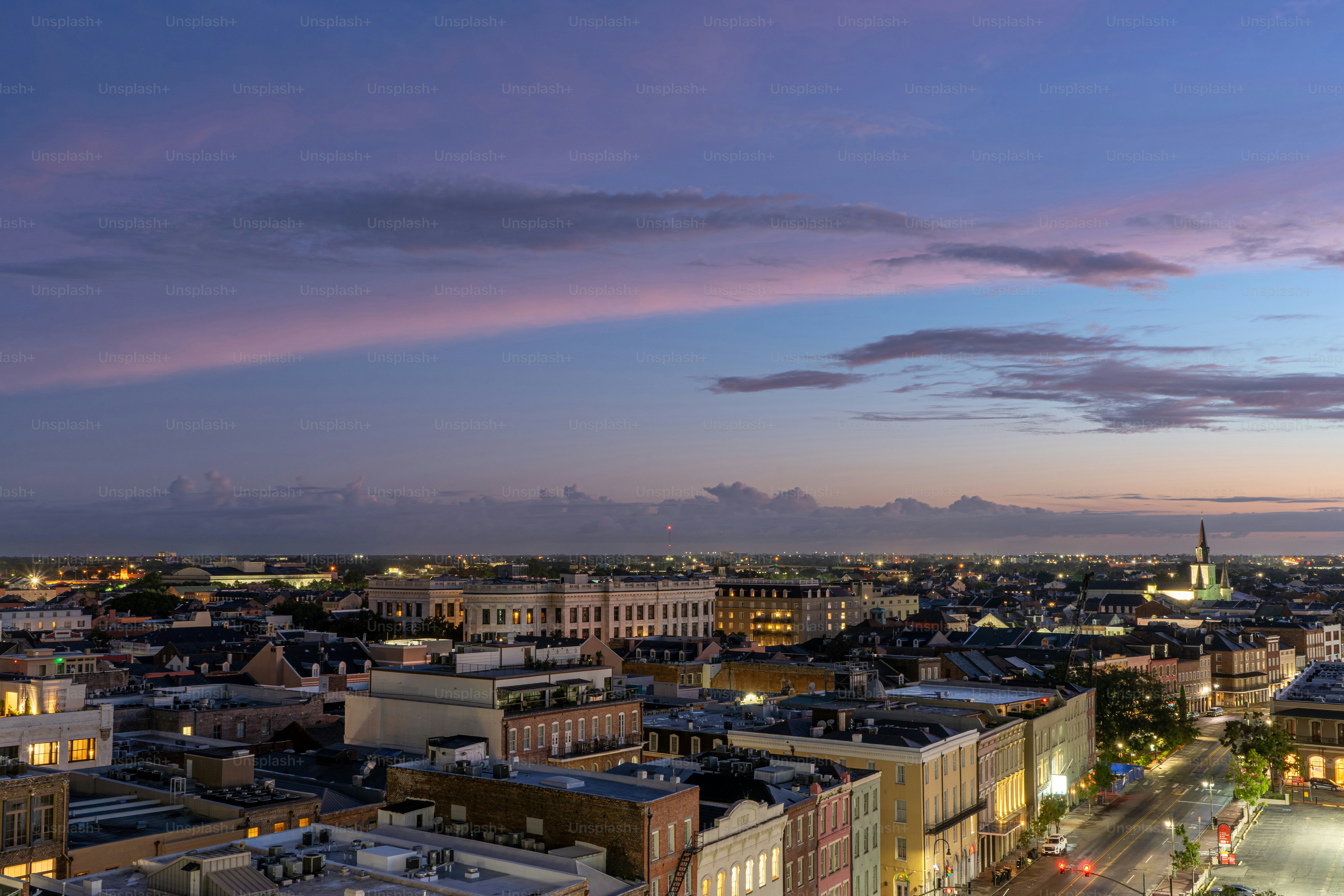 A vibrant and colorful sunrise explodes over the French Quarter of New Orleans, Louisiana in the early hours of the day.