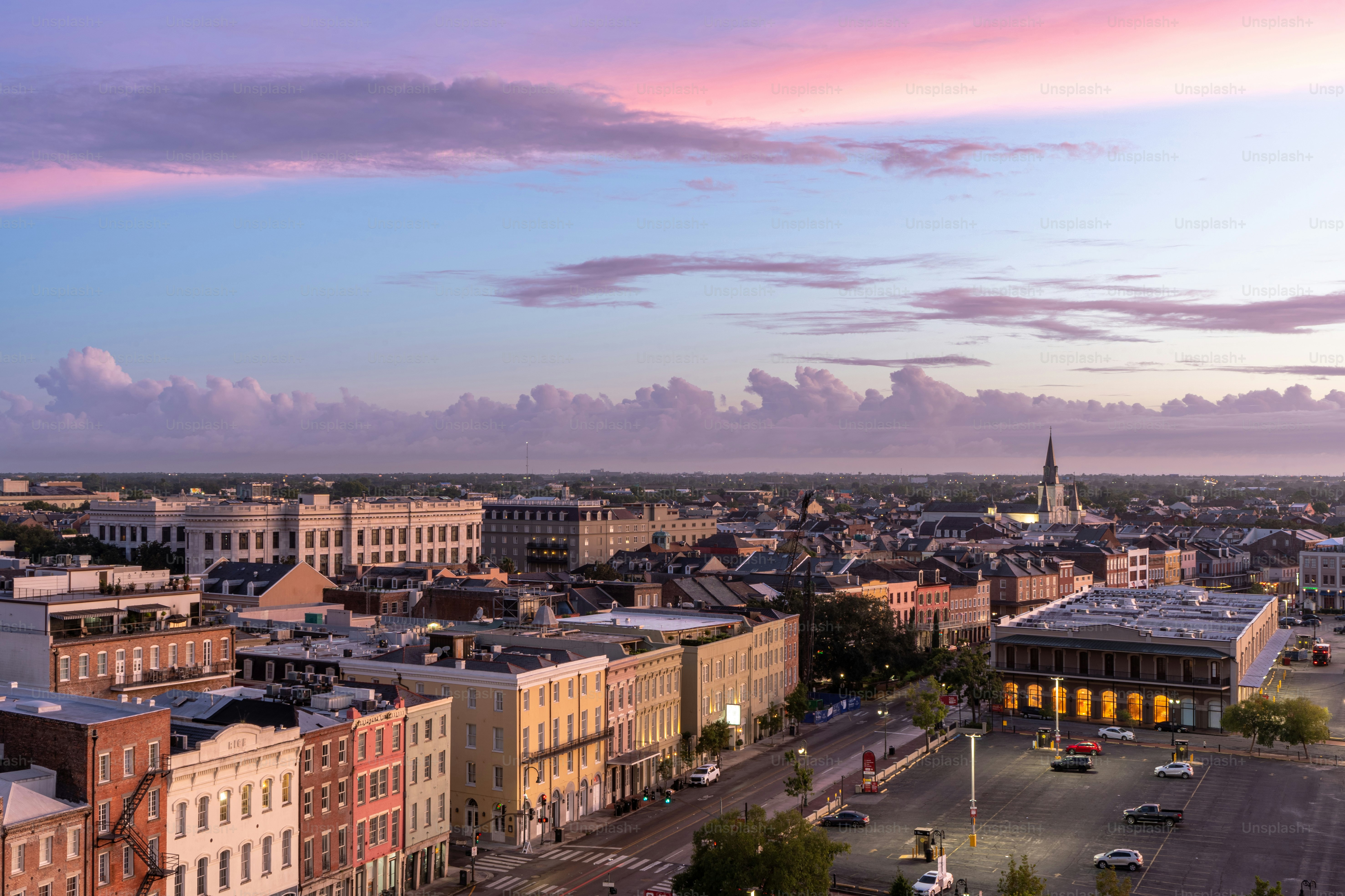 A vibrant and colorful sunrise explodes over the French Quarter of New Orleans, Louisiana in the early hours of the day.