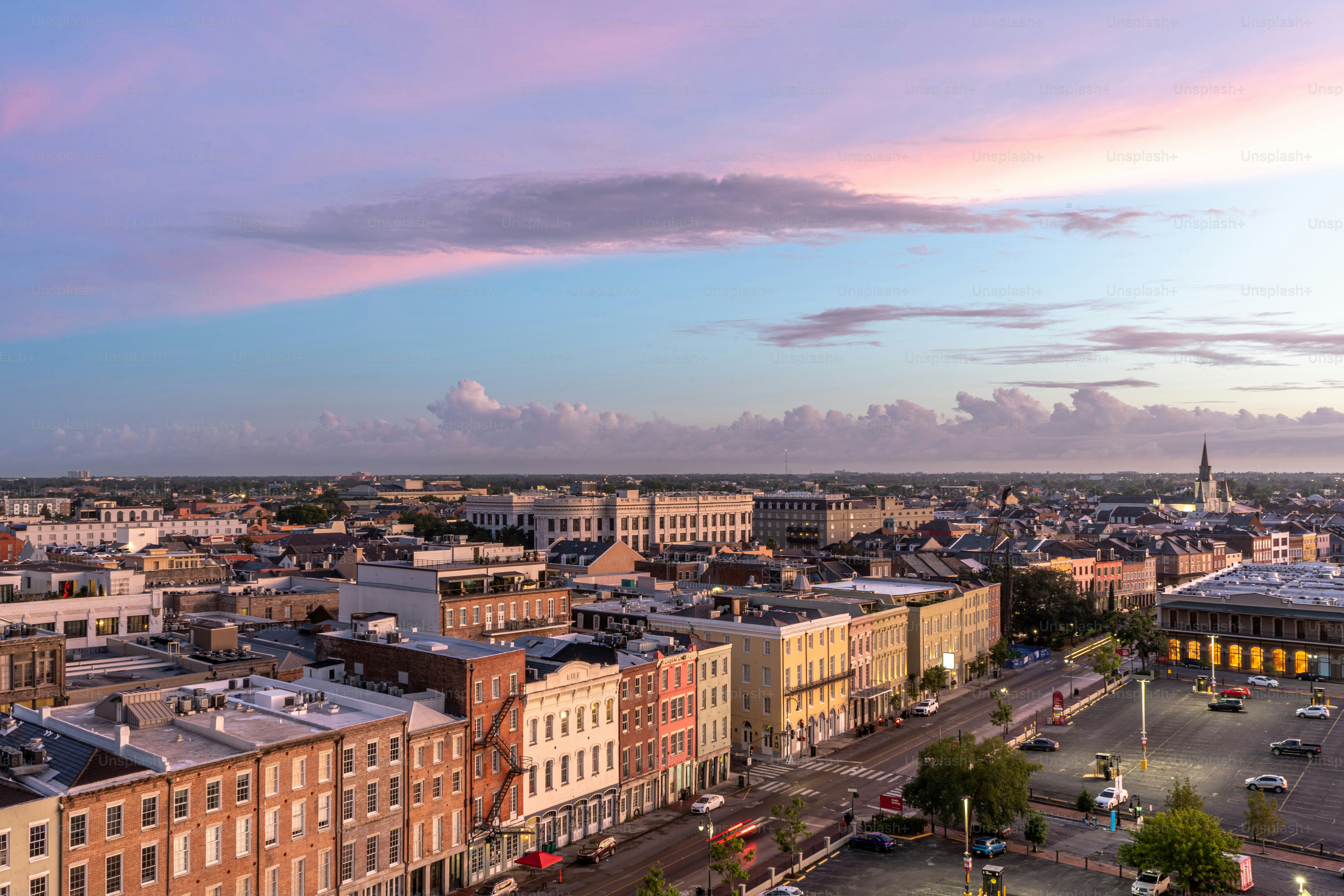 A vibrant and colorful sunrise explodes over the French Quarter of New Orleans, Louisiana in the early hours of the day.