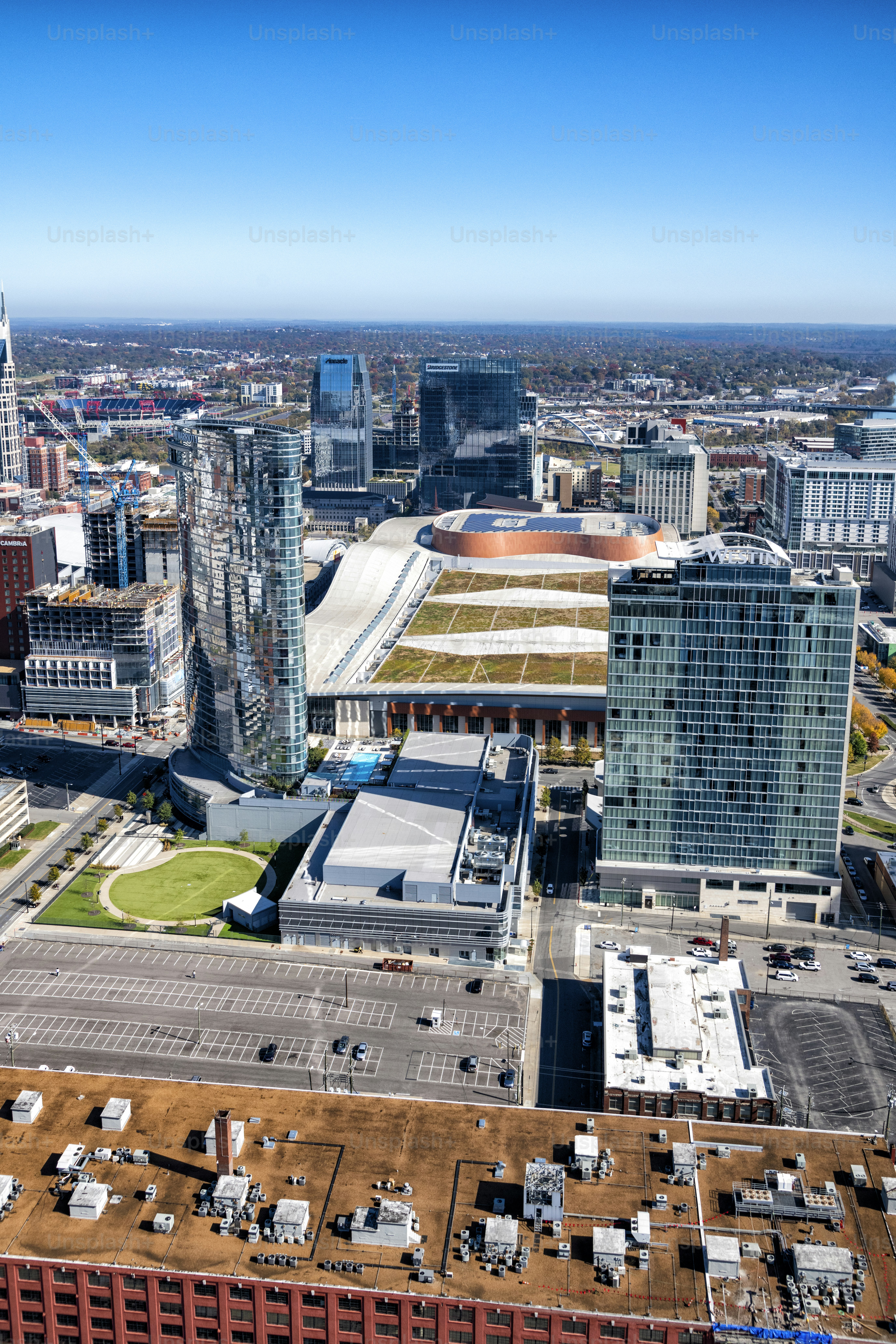 The convention center in downtown Nashville, Tennessee surrounding by downtown high-rise building from an altitude of about 800 feet over the city.