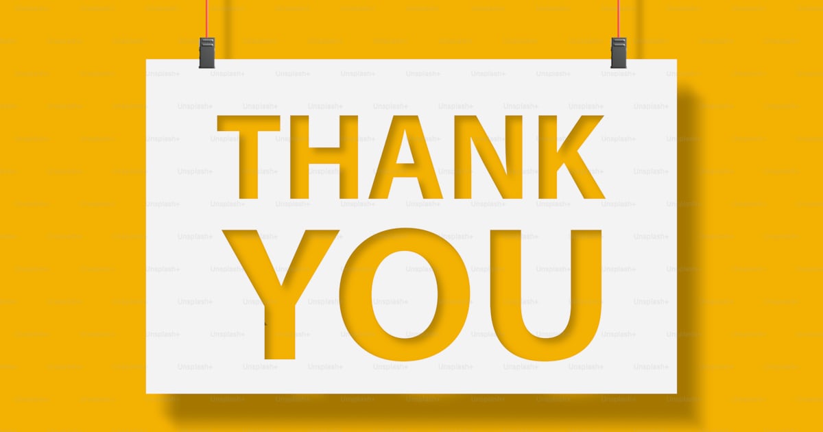 Thank you message on paper hanging with rope on yellow background photo ...