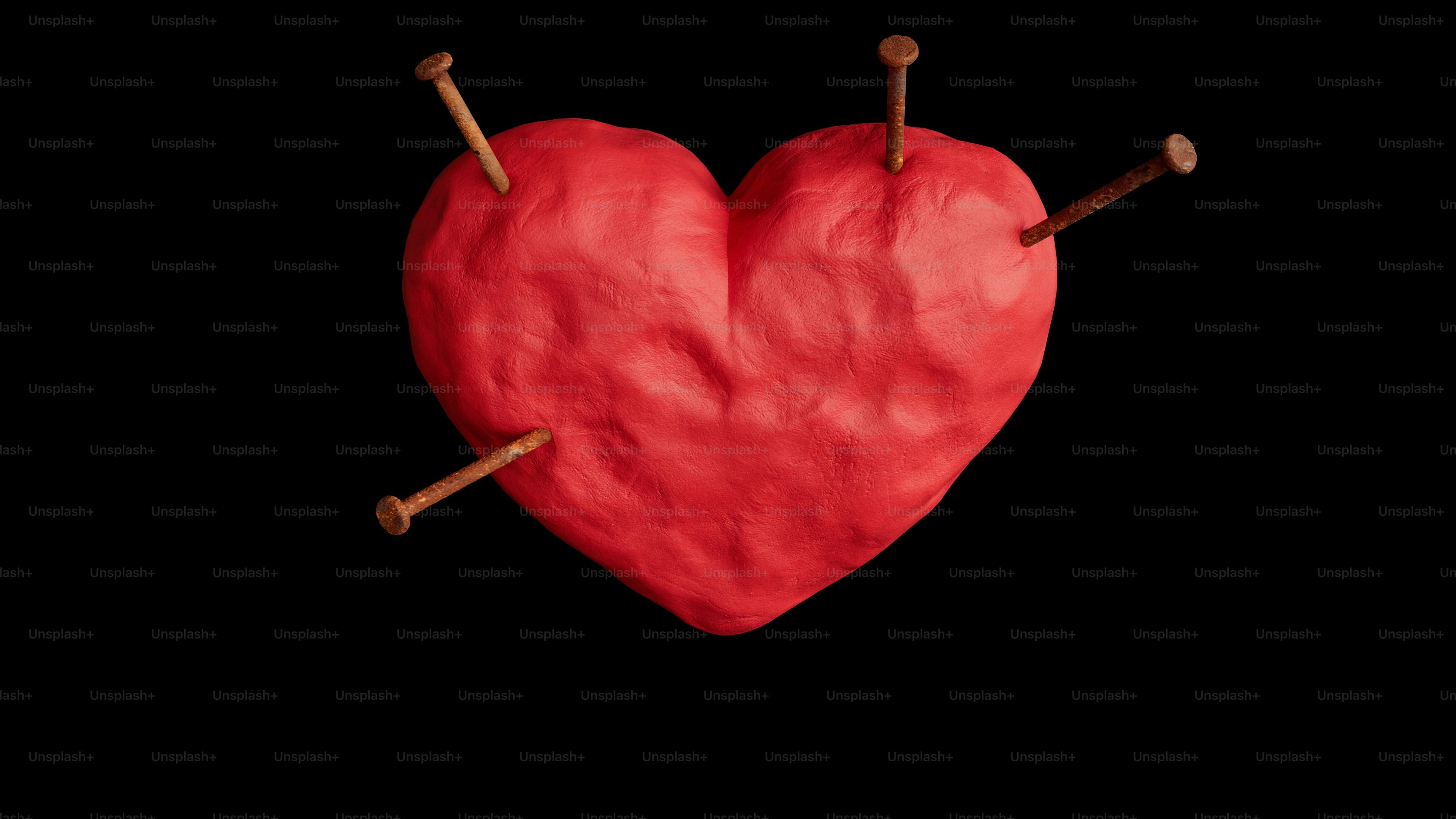 A red heart with two sticks sticking out of it