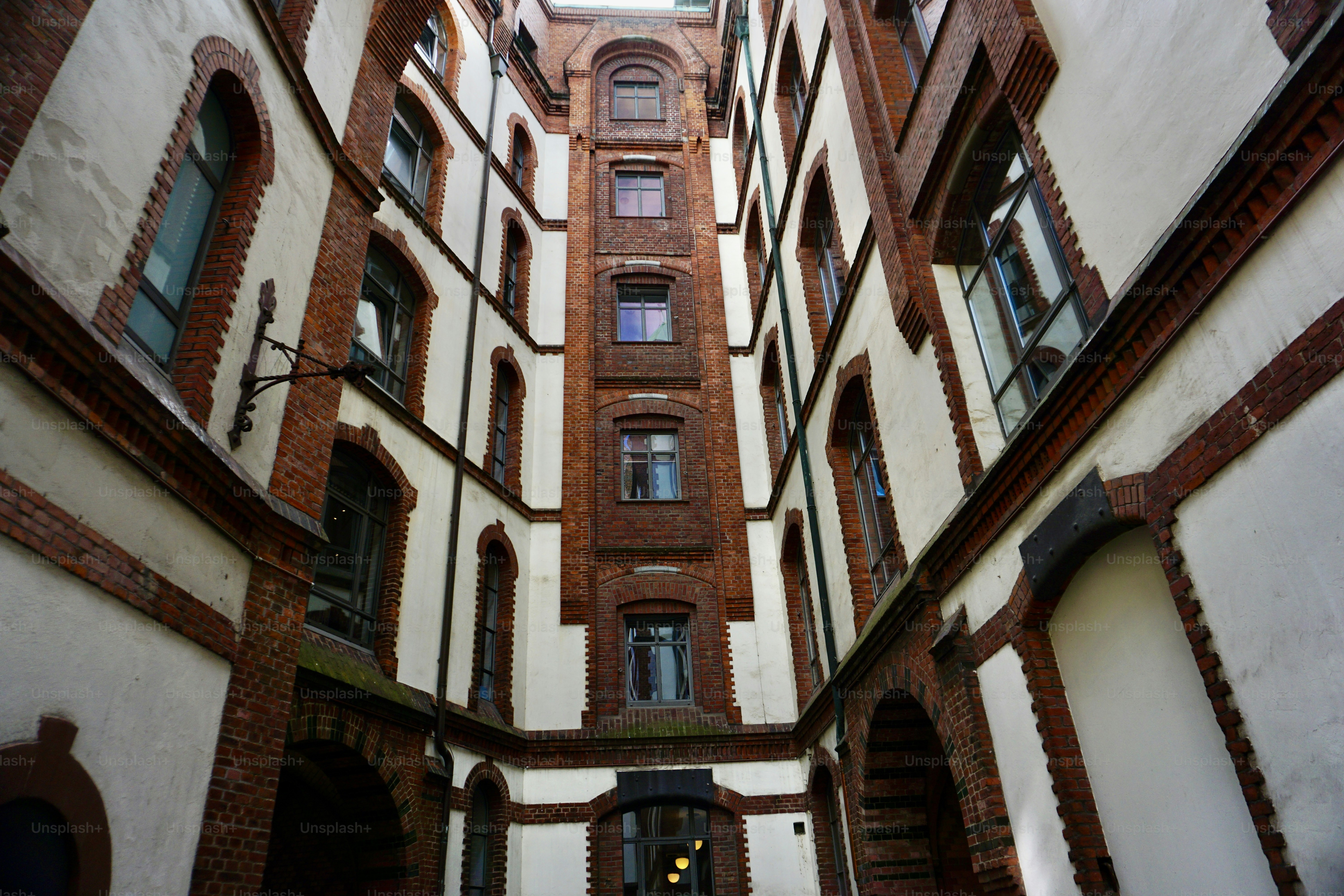 An empty enclosed courtyard. An old building and a rounded enclosed courtyard. Bicycles parked in the courtyard of an old house. Rounded enclosed courtyard.