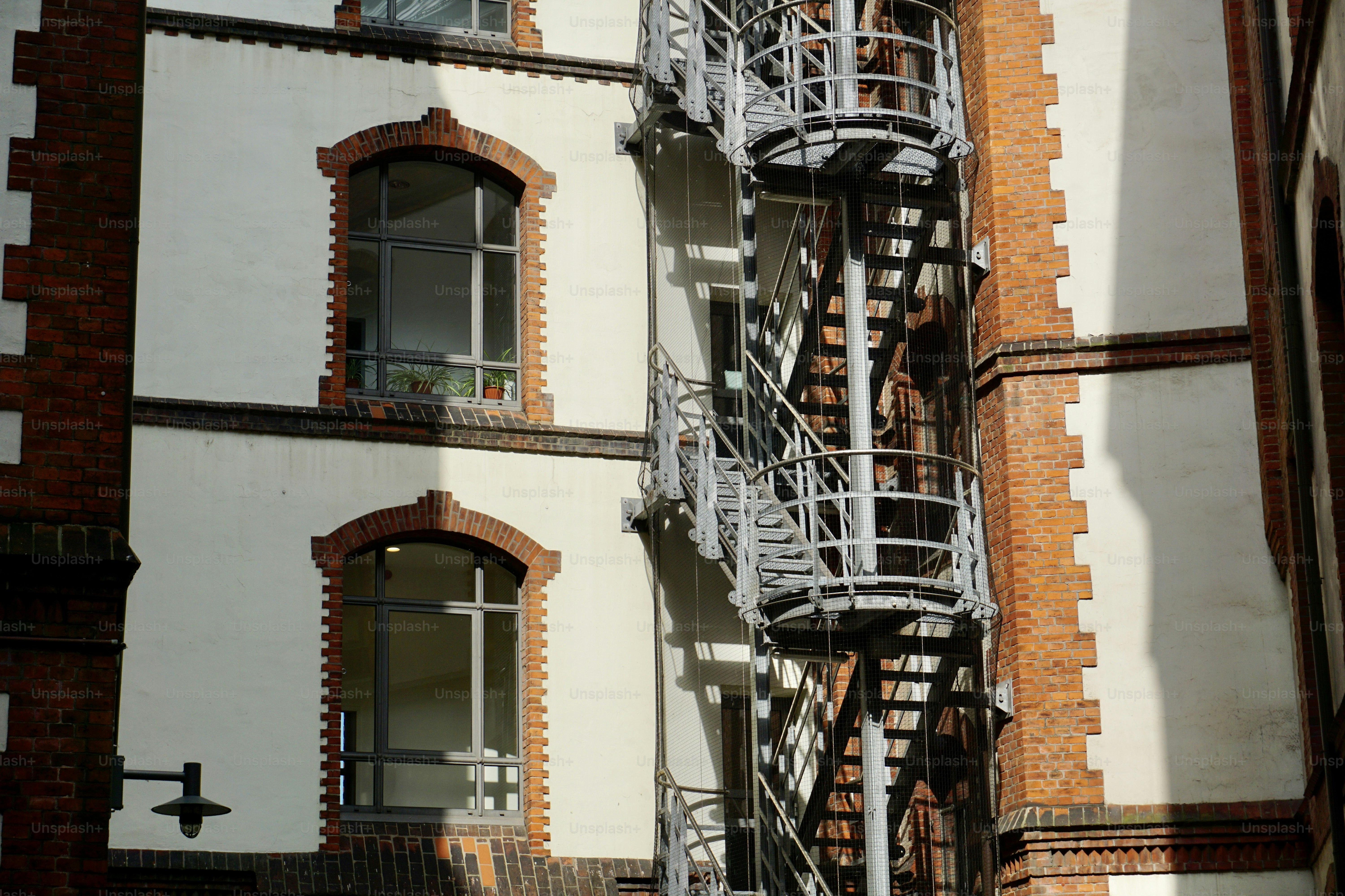 An empty enclosed courtyard. An old building and a rounded enclosed courtyard. Bicycles parked in the courtyard of an old house. Rounded enclosed courtyard.