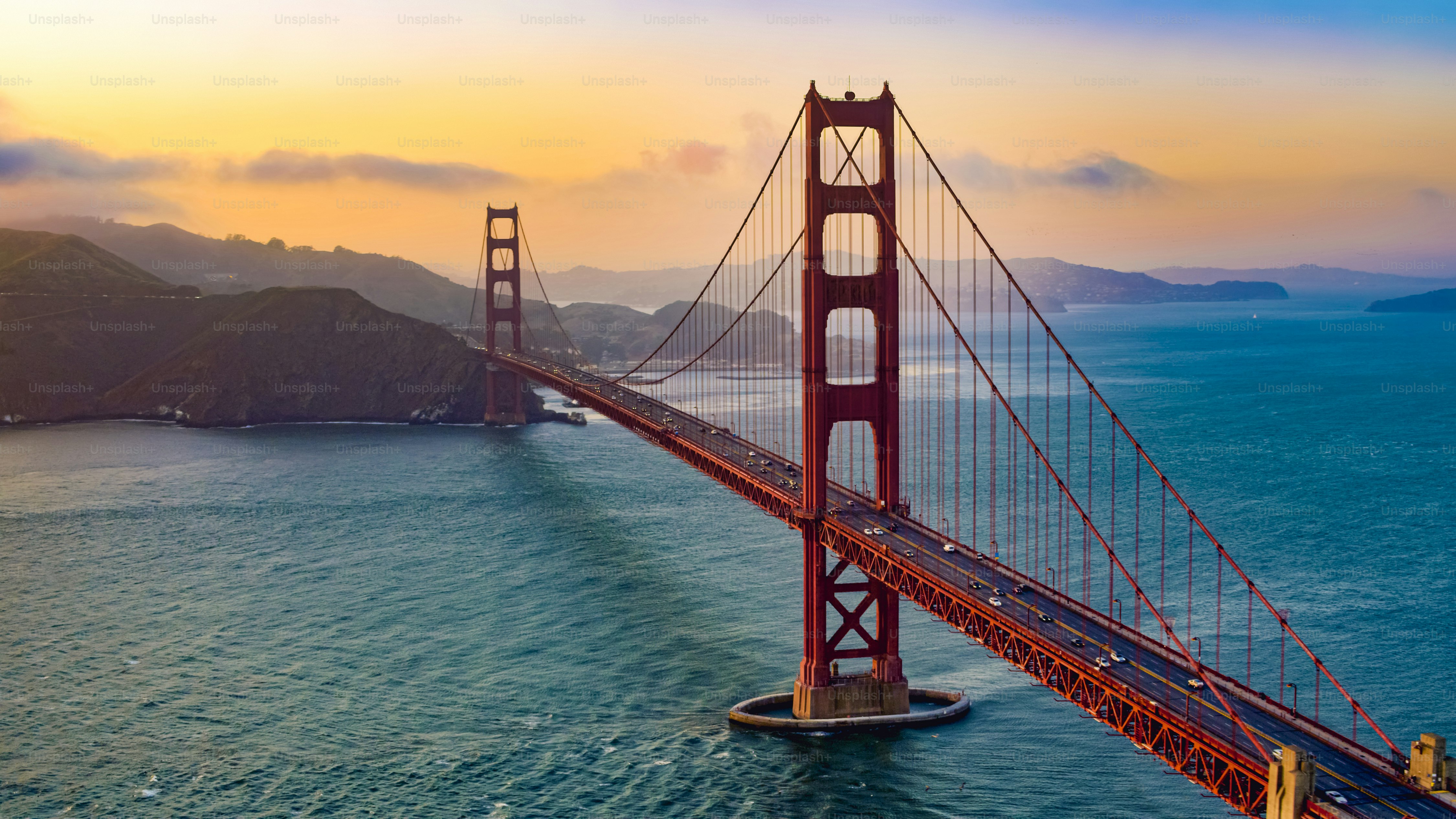 Aerial view of traffic moving on Golden Gate Bridge during sunset, San Francisco, California, USA