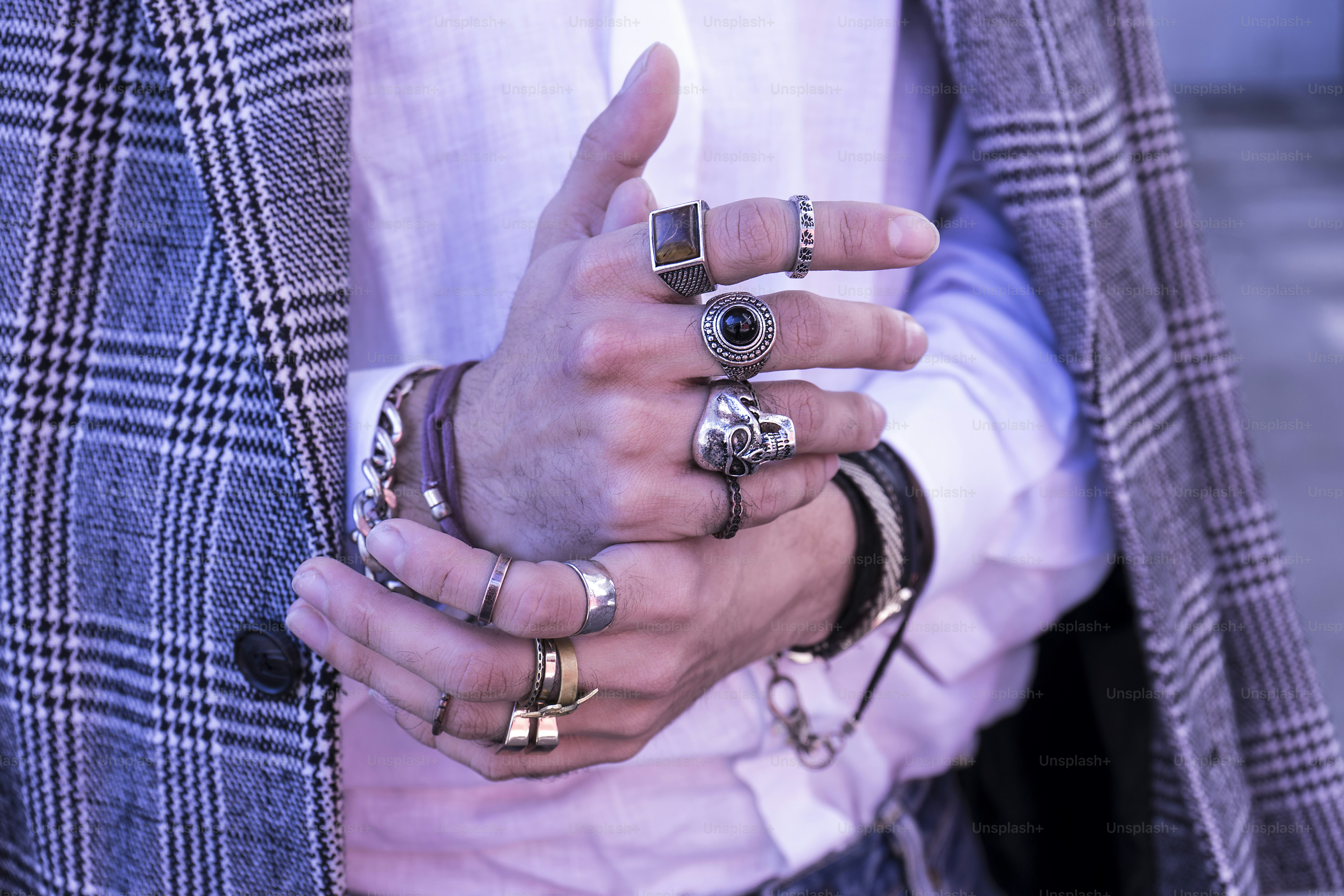 Stylish Modern Man: Handsome Hands with Trendy Silver Bracelets and Rings with skull