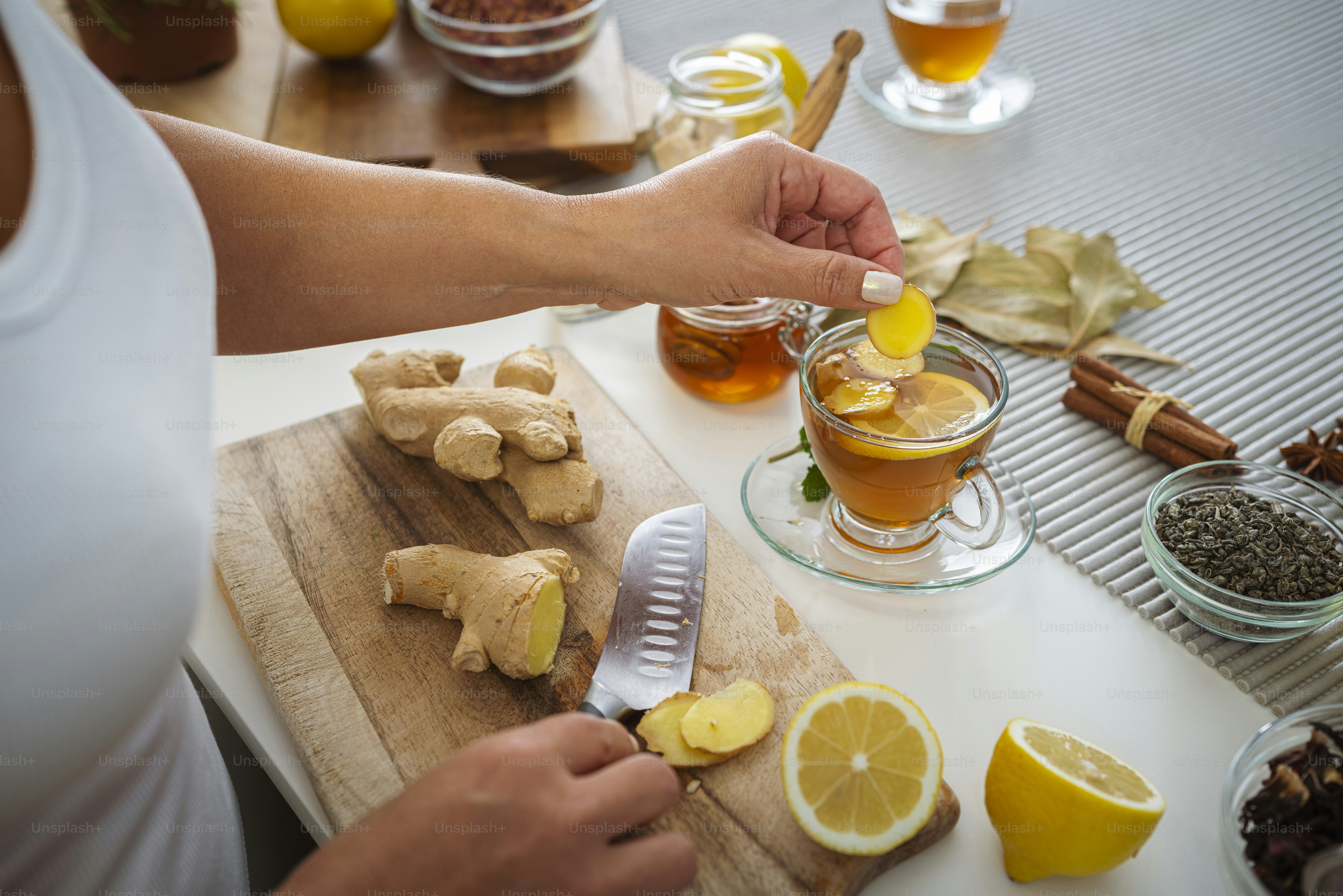 Woman preparing ginger and lemon hot tea