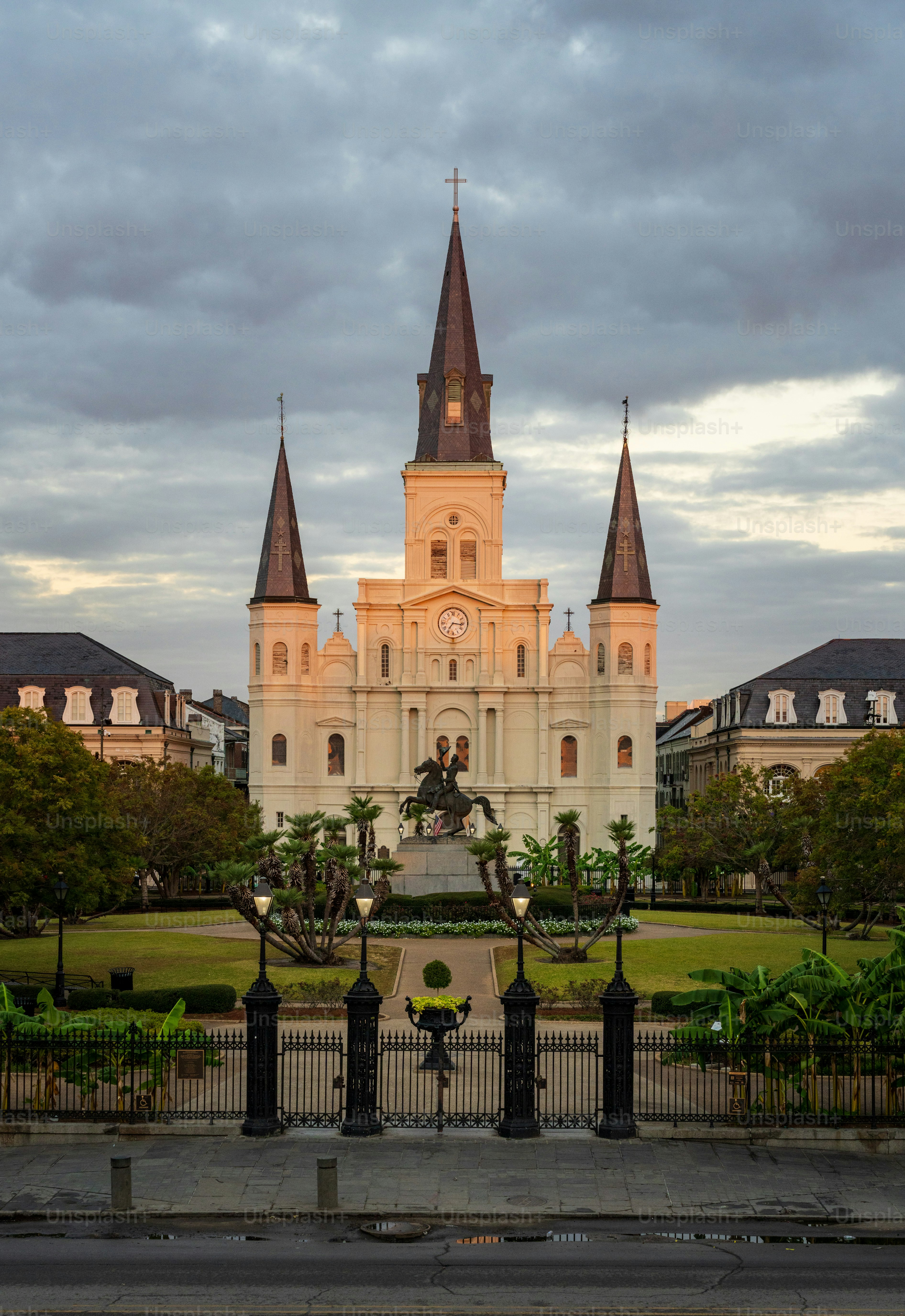 Rays from rising sun hit the facade of the Cathedral of St Louis, King of France with statue of Andrew Jackson in New Orleans in Louisiana
