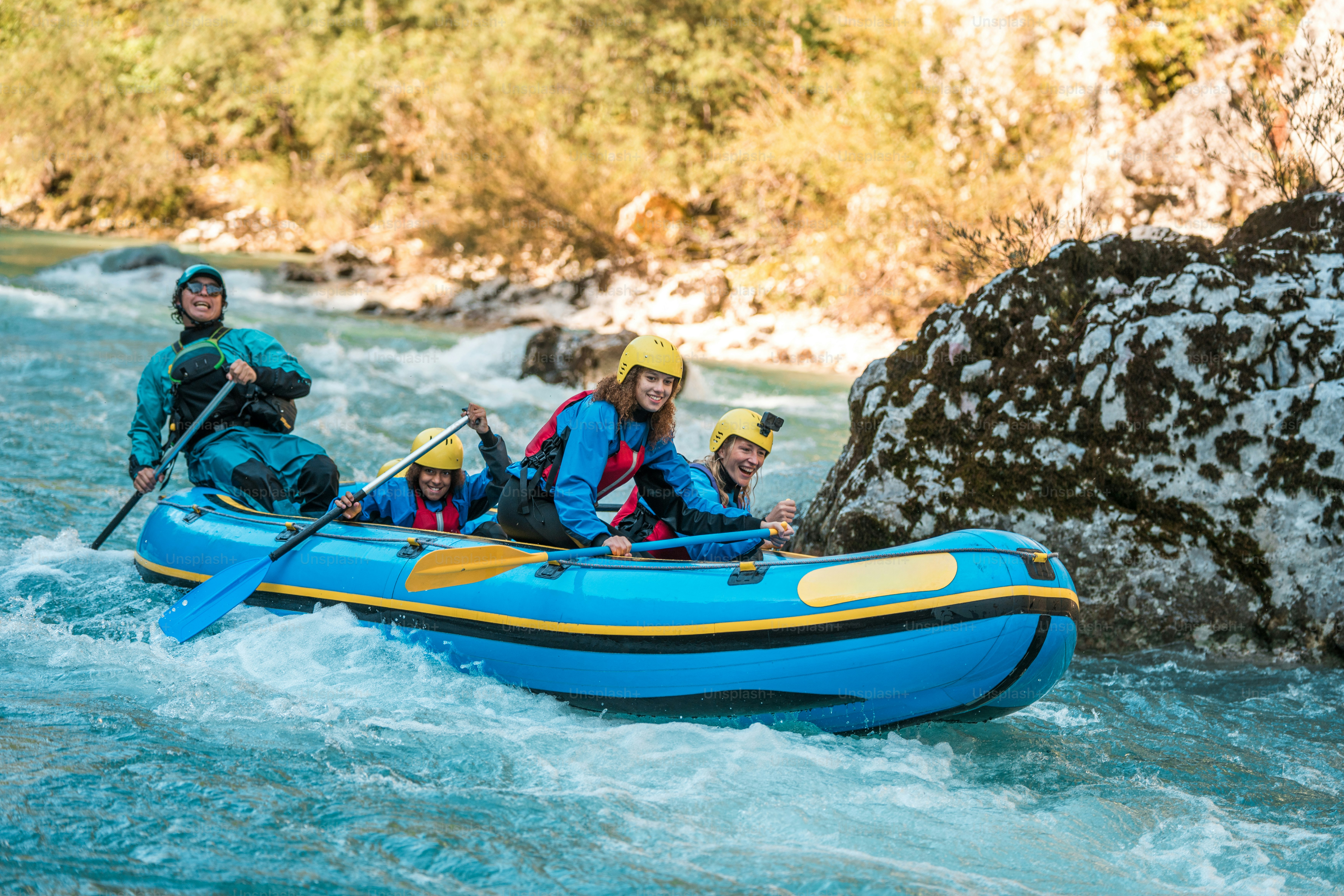 A young Caucasian mother and her children accompanied by a professional guide, navigating the challenges of a river rafting journey together.