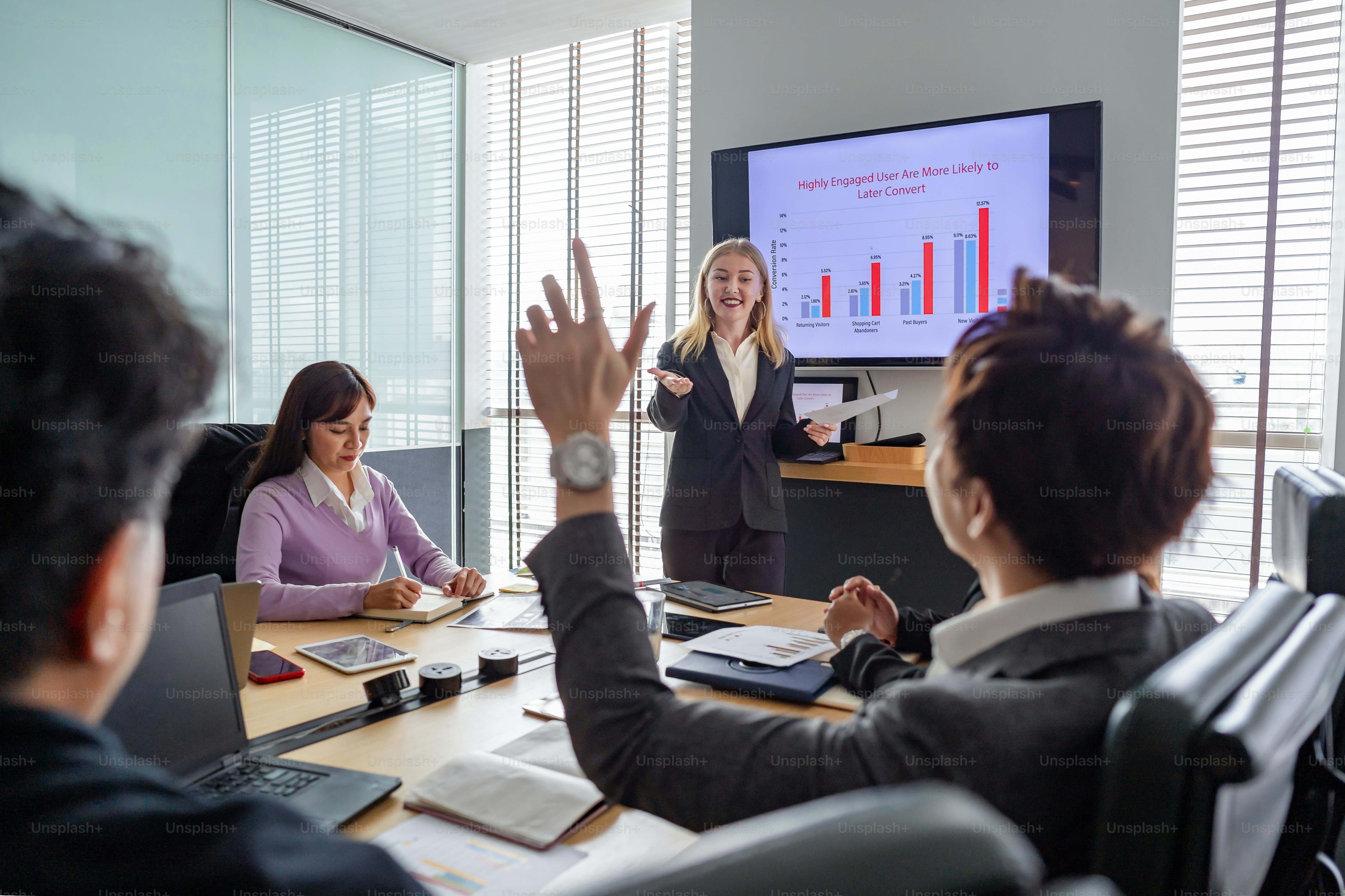 Business meeting at office, woman presenting the meeting using TV for presentation