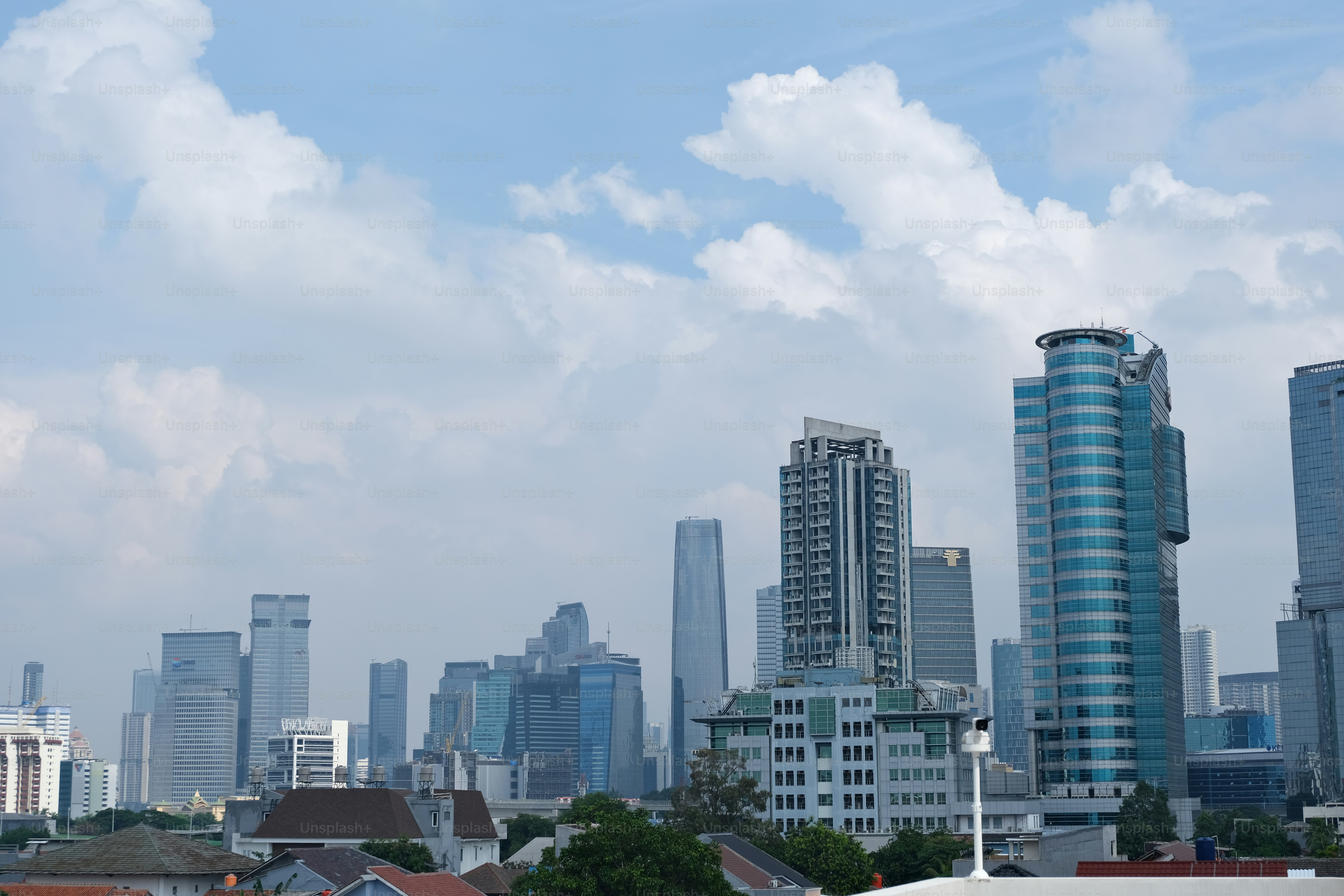 Cityscape of Jakarta with tall skyscrapers building and traditional house building
