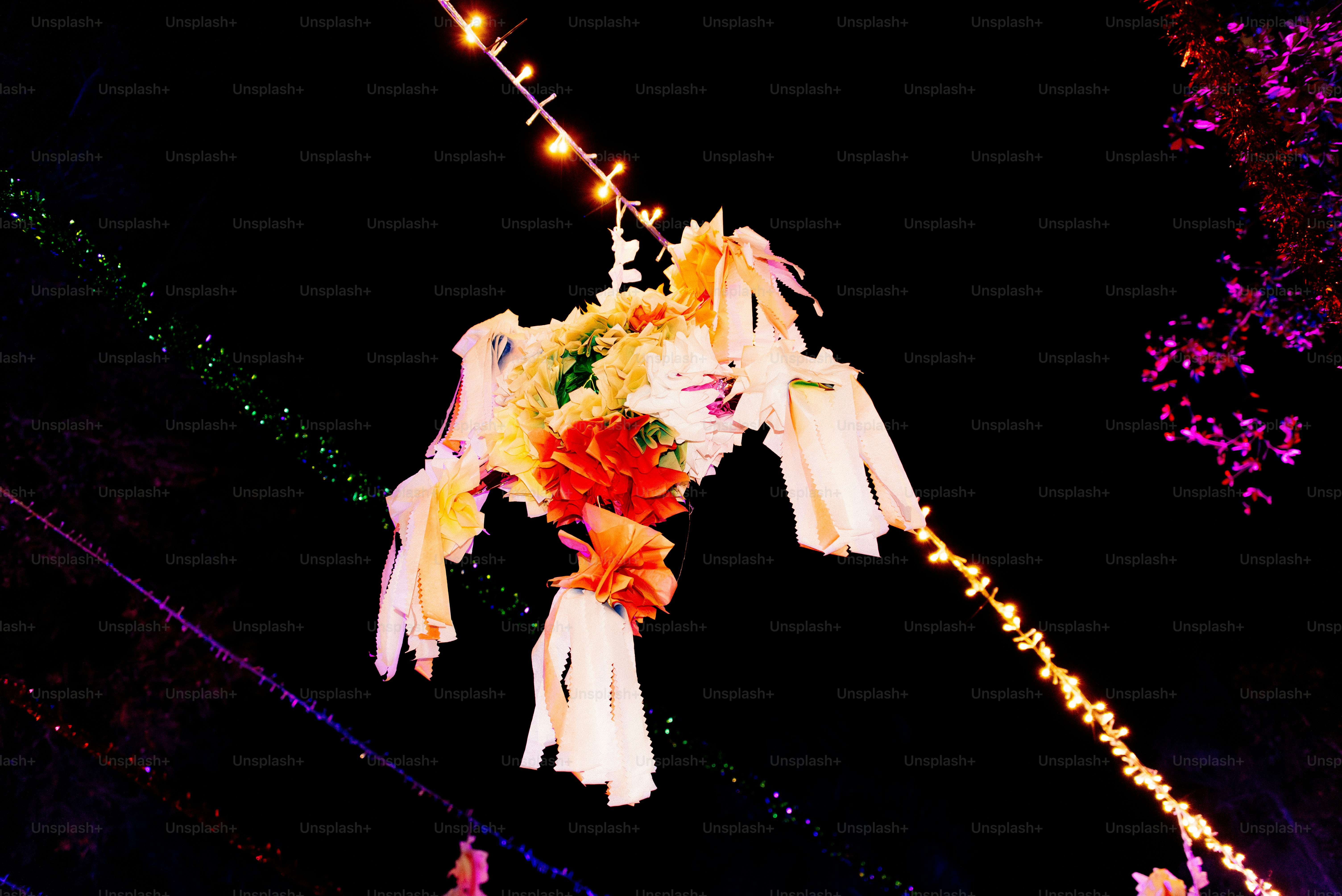 A colorful display of flowers and lights in the dark