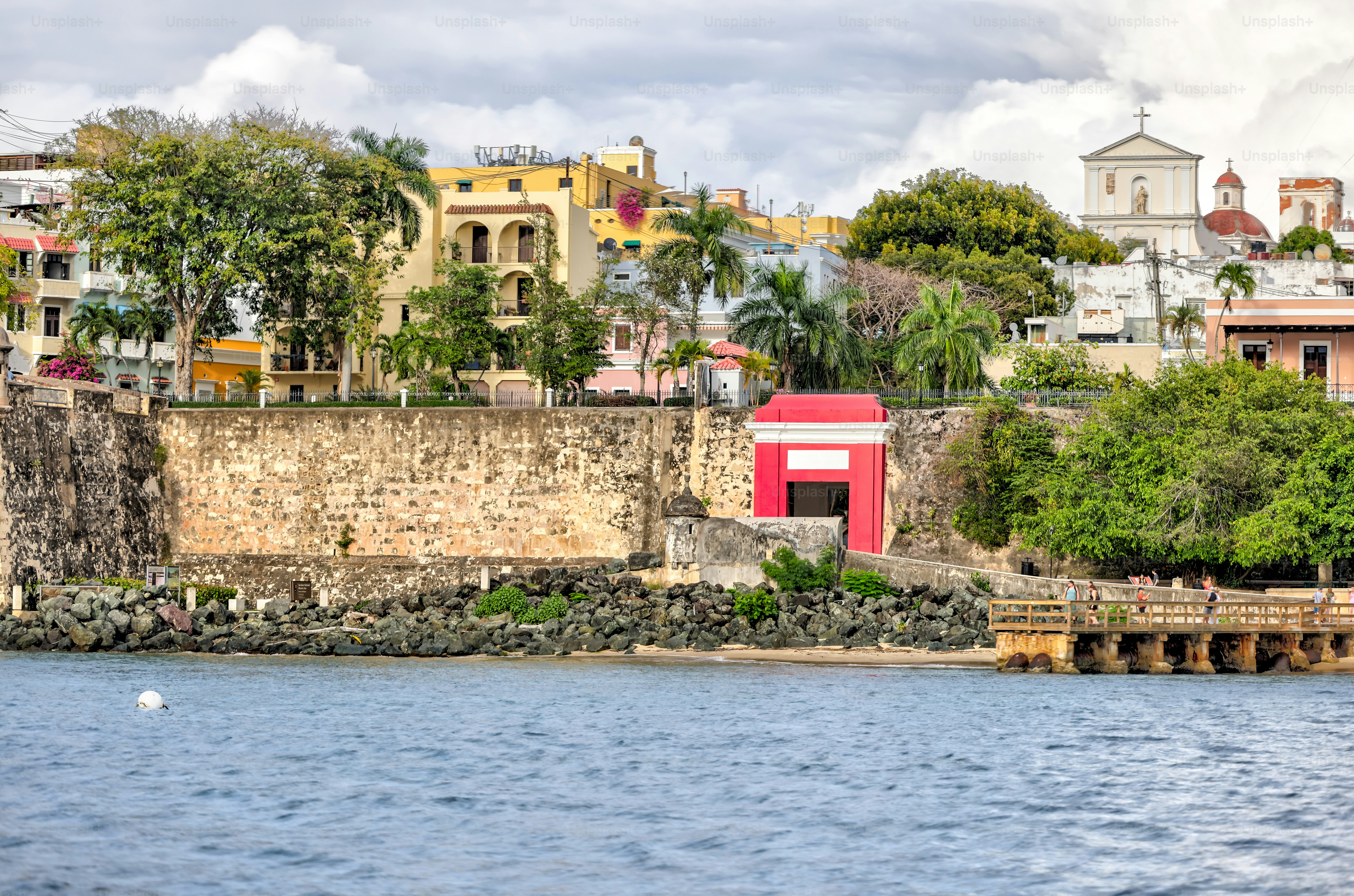 San Juan, Puerto Rico - March 26, 2024: View from the water of the forttified walls and old town of San Juan, Puerto Rico