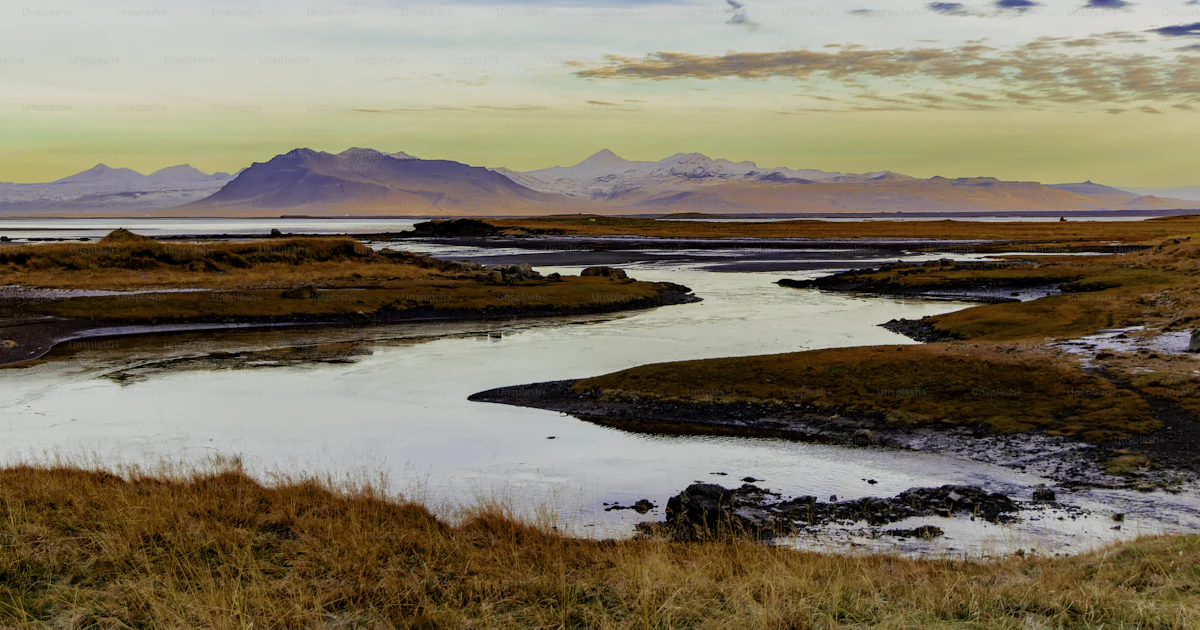 Deep Rivers Run Quiet A beautiful landscape with a river running through it. The water is ...