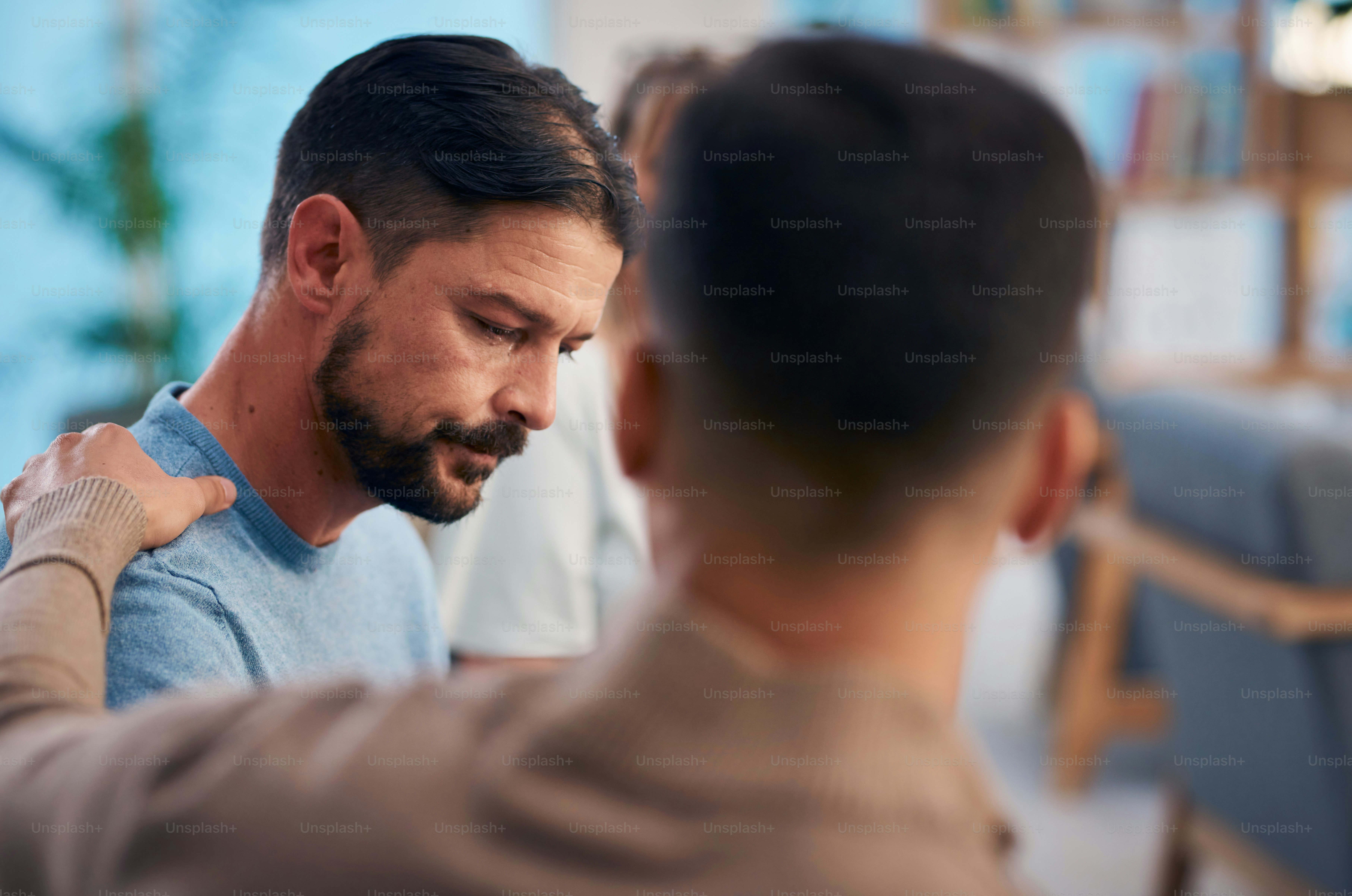 A touching moment during a support group session, showing a diverse group of people offering emotional support. The image captures empathy, encouragement, and the importance of community in difficult times.