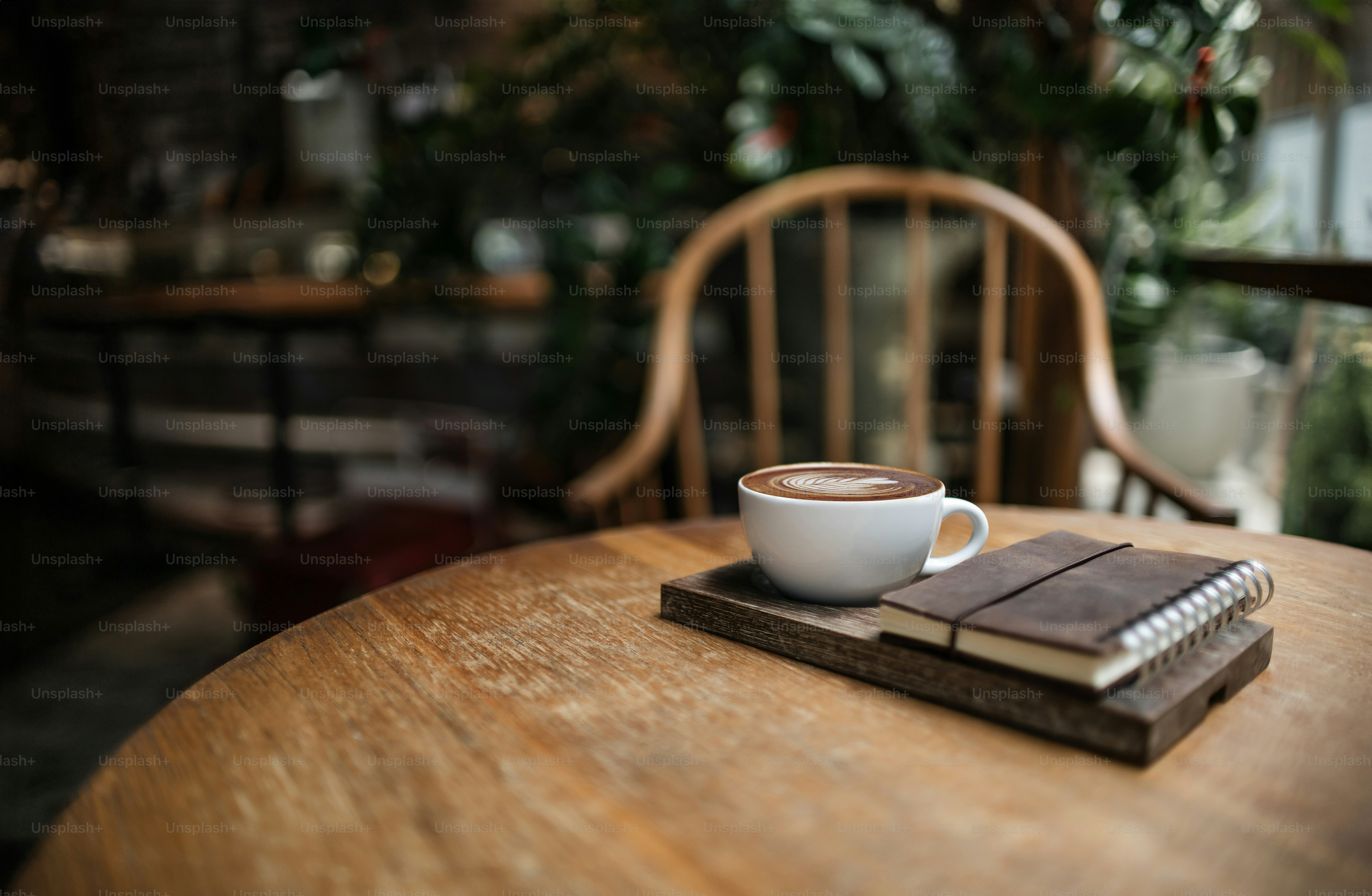 Latte coffee with old book put on plank on wooden table, retro style