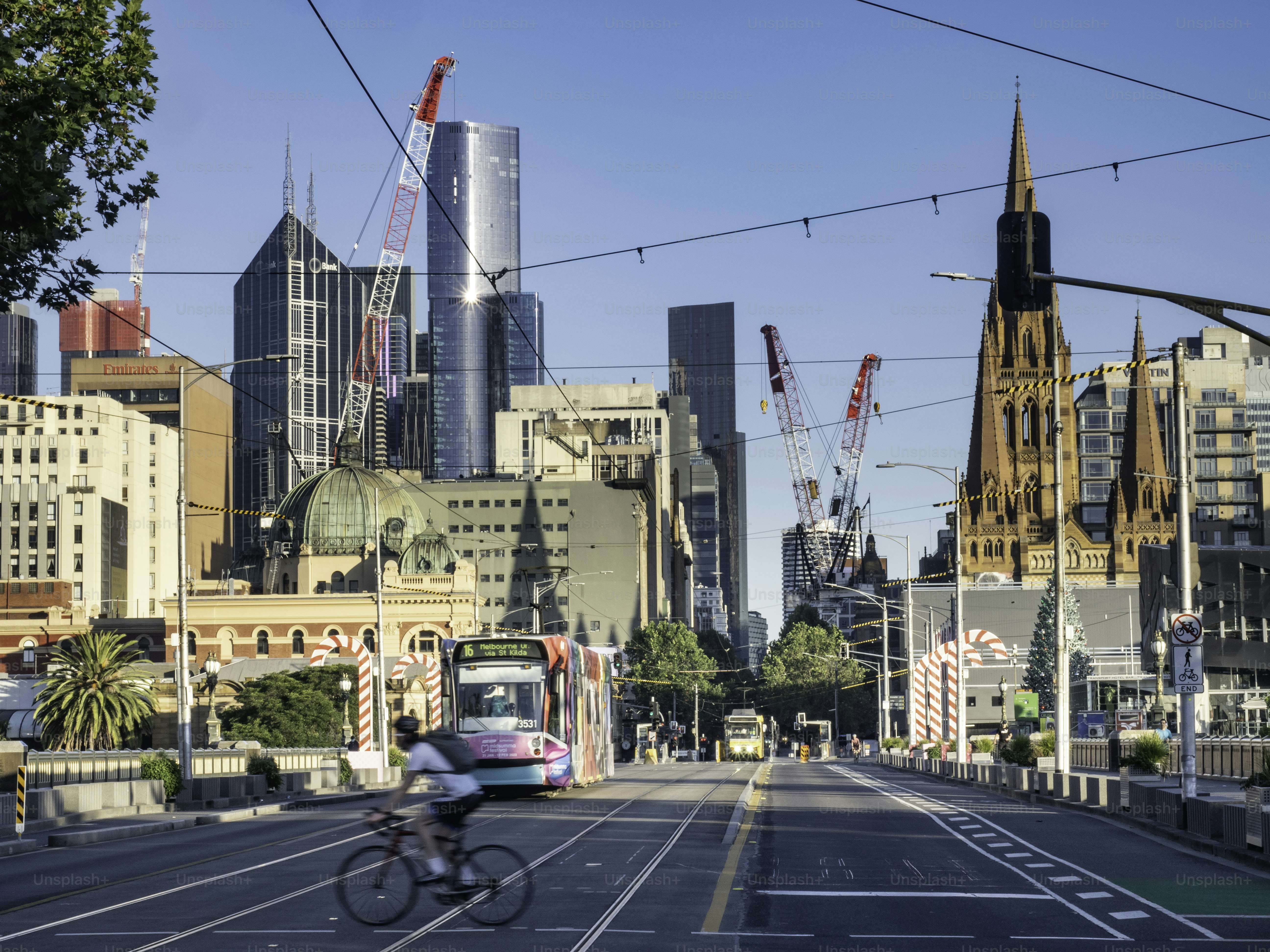Melbourne's St Kilda Road, tram and crossing cyclist early morning